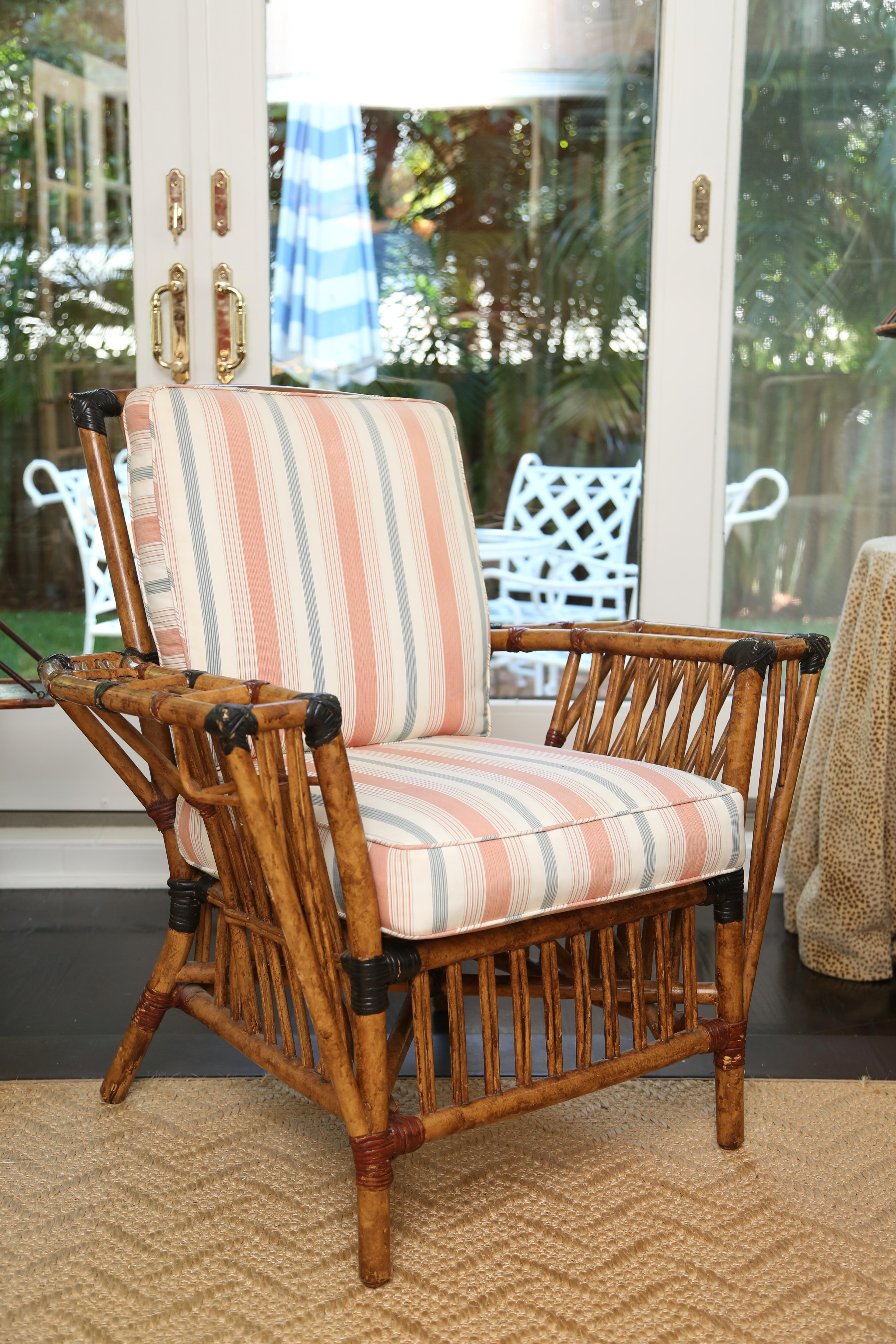 Pair of Classic president chairs with room or your favourite magazine and dockail on either side. Lovely woven details on either side. Fabric is now a Classic light blue and coral stripe.