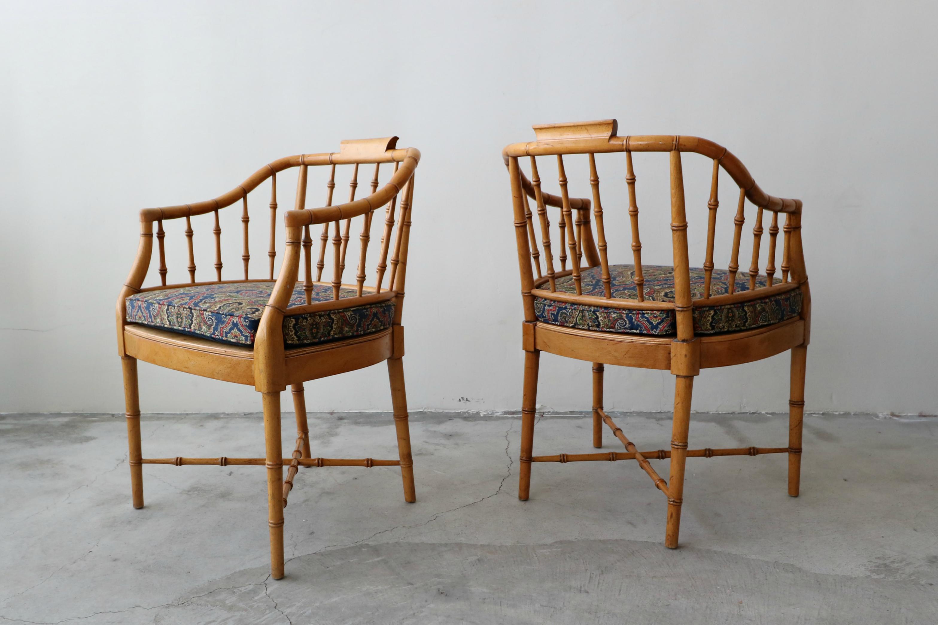 Nice pair of vintage faux wood bamboo accent chairs by Baker. Can be used with their removable seat cushions or without, for a more Minimalist look. The seat cushions have been professionally reupholstered with all new foam and fabric. The chairs
