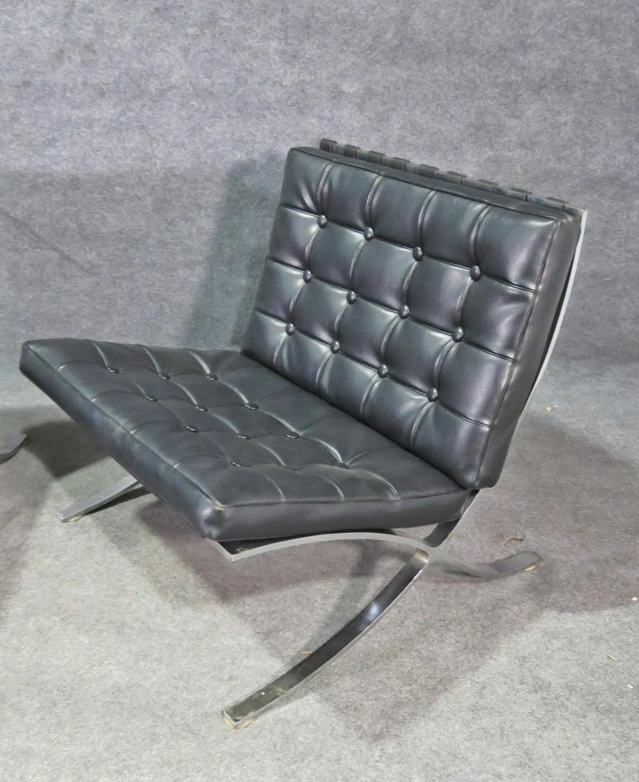 An elegant and comfortable pair of Barcelona style chairs in chrome and black vinyl upholstery. Please confirm item location with seller (NY/NJ).
