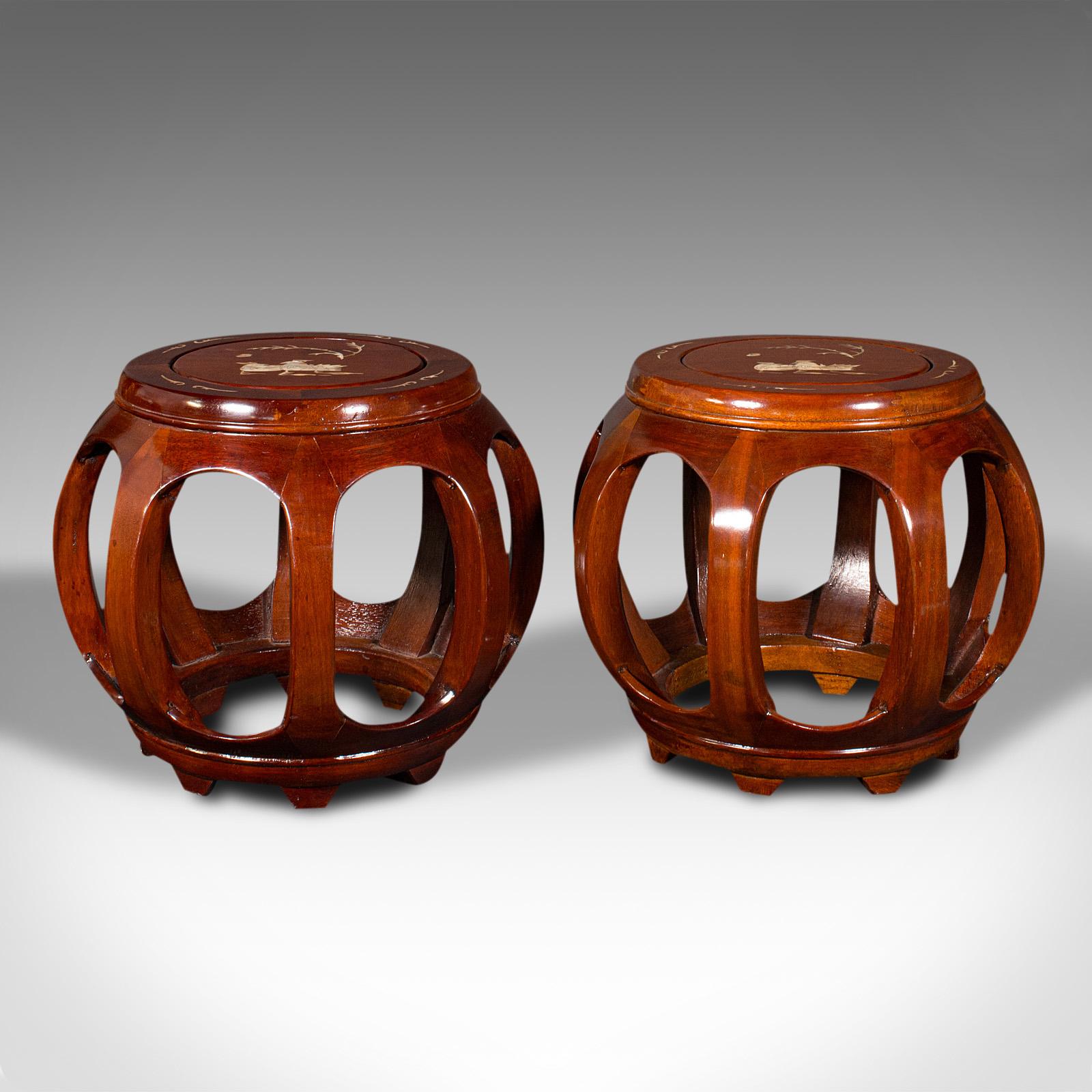 This is a pair of vintage barrel stools. A Chinese, mahogany and mother of pearl inlaid decorative display stand, dating to the late 20th century, circa 1970.

Distinctive accent pieces with great colour and unusual form
Displaying a desirable aged