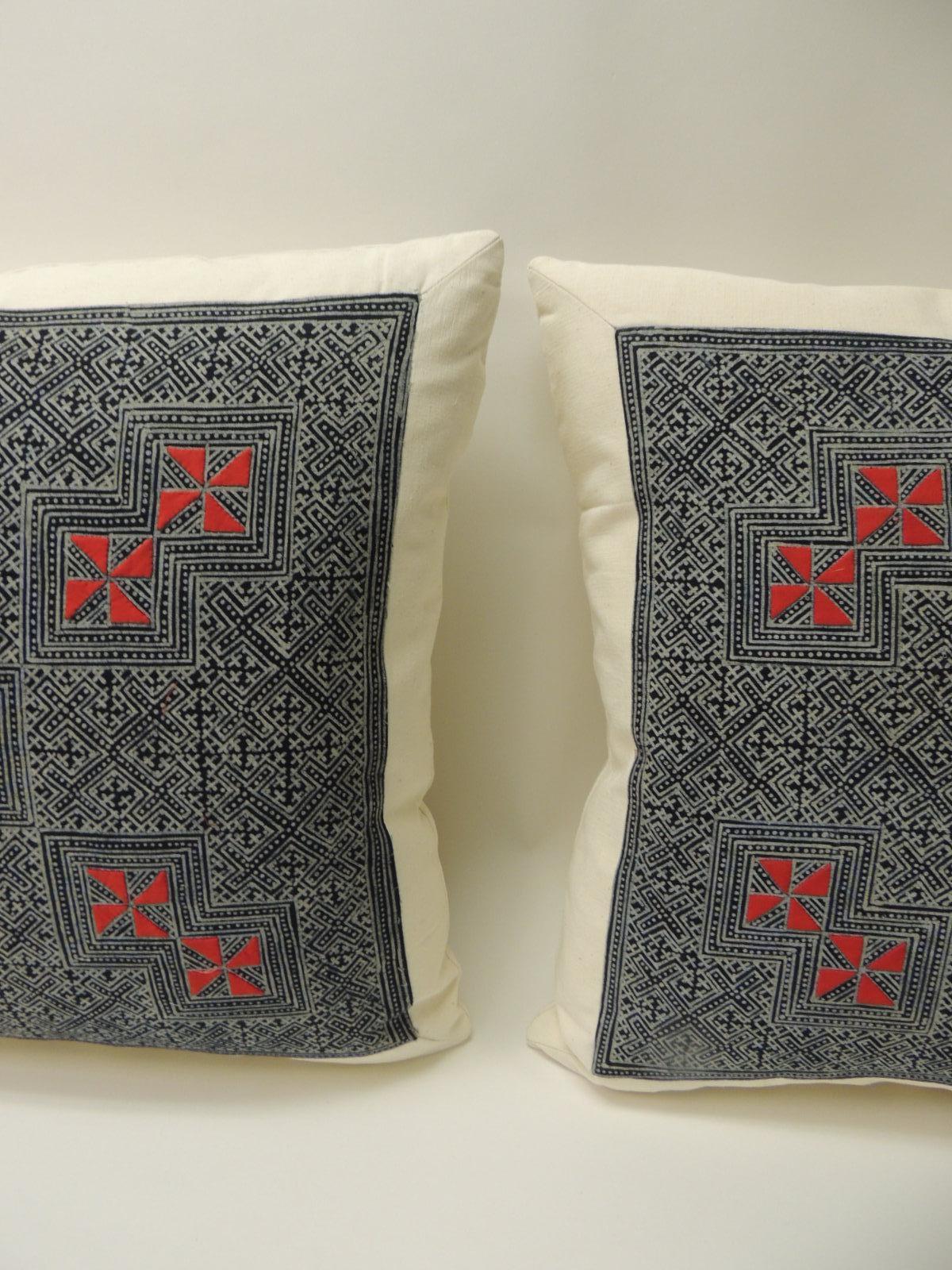 Pair of vintage Asian hand blocked red and indigo square decorative pillows
Decorative square pillows handcrafted with a vintage Asian hand blocked batik red and indigo textile. The decorative pillows depict a hand blocked technique in the front