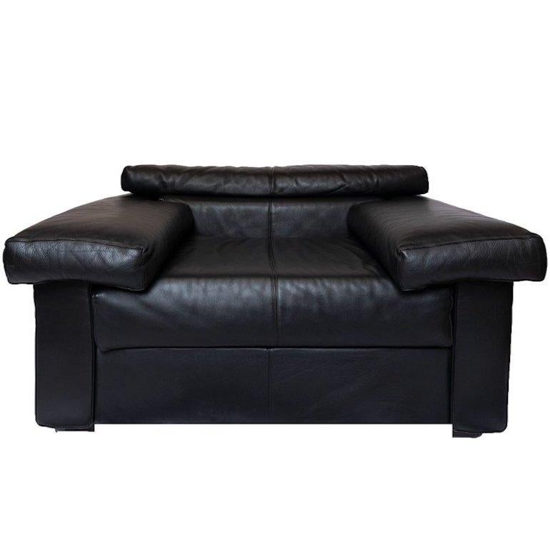 Legendary pair of leather Erasmo lounge chairs by the famed Italian designer duo Afra & Tobia Scarpa, manufactured in Novedrate (Como), north of Milan by B&B Italia. Signed, circa 1980s.
Light scuffs, scratches, and patina on black leather due to