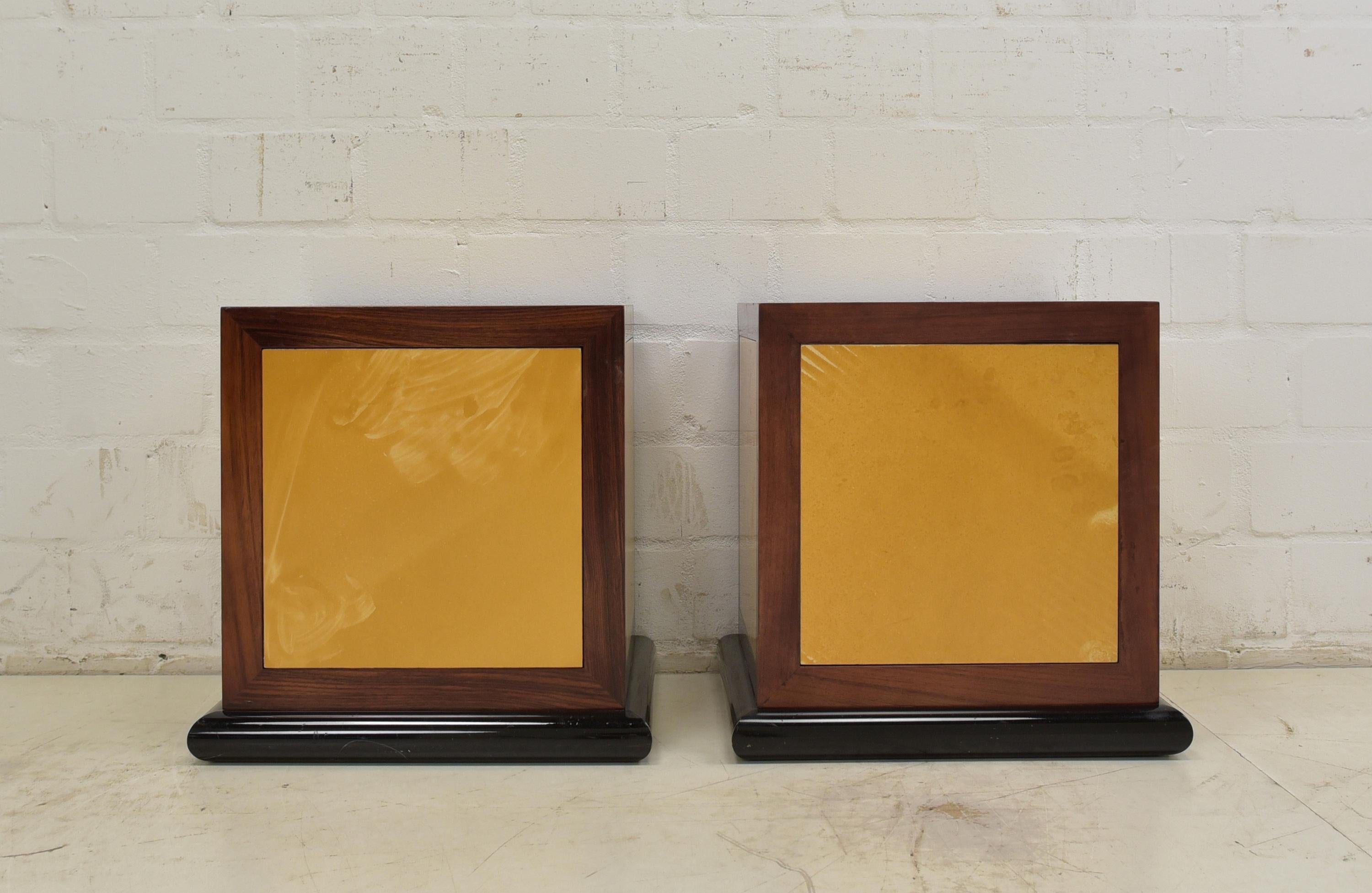 Pair of bedside tables Cube design retro 80s 90s vintage

Features:
Solid rosewood frame dice with yellow panels on a tubular metal base
One invisible door with pressure lock
High quality
Very nice design

Additional information:
Material: