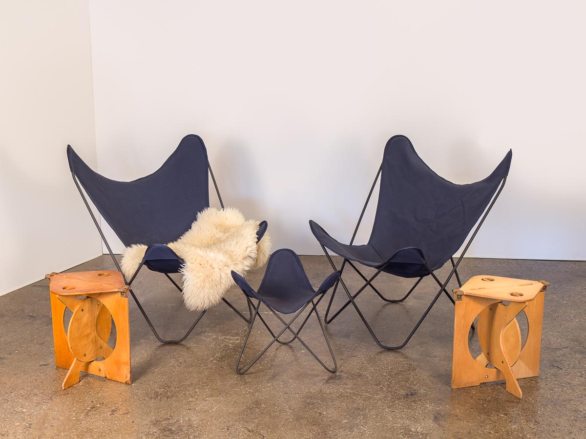 Pair of vintage BKF Hardoy butterfly chairs for Knoll. Dynamic Classic form, for indoor or outdoor use. Navy blue canvas slings are new, and in excellent condition with no holes, rips, or tears. Frames match beautifully, with all welds intact and