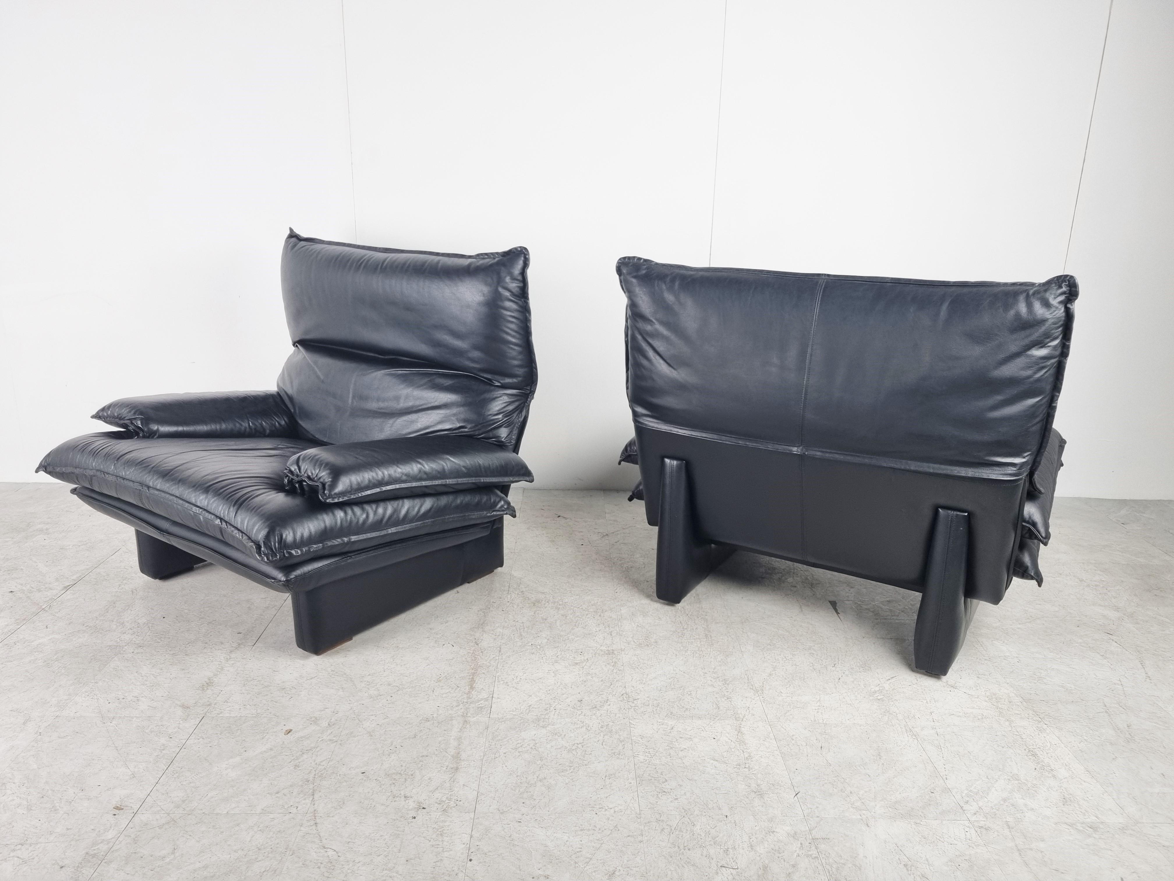 Pair of very comfortable black leather armchairs from Italy.

The headrest is adjustable.

Tthe chairs are very comfortable thanks to the thick leather cushions.

The armchairs seems to be very much inspred by the maralunga sofas from Vico