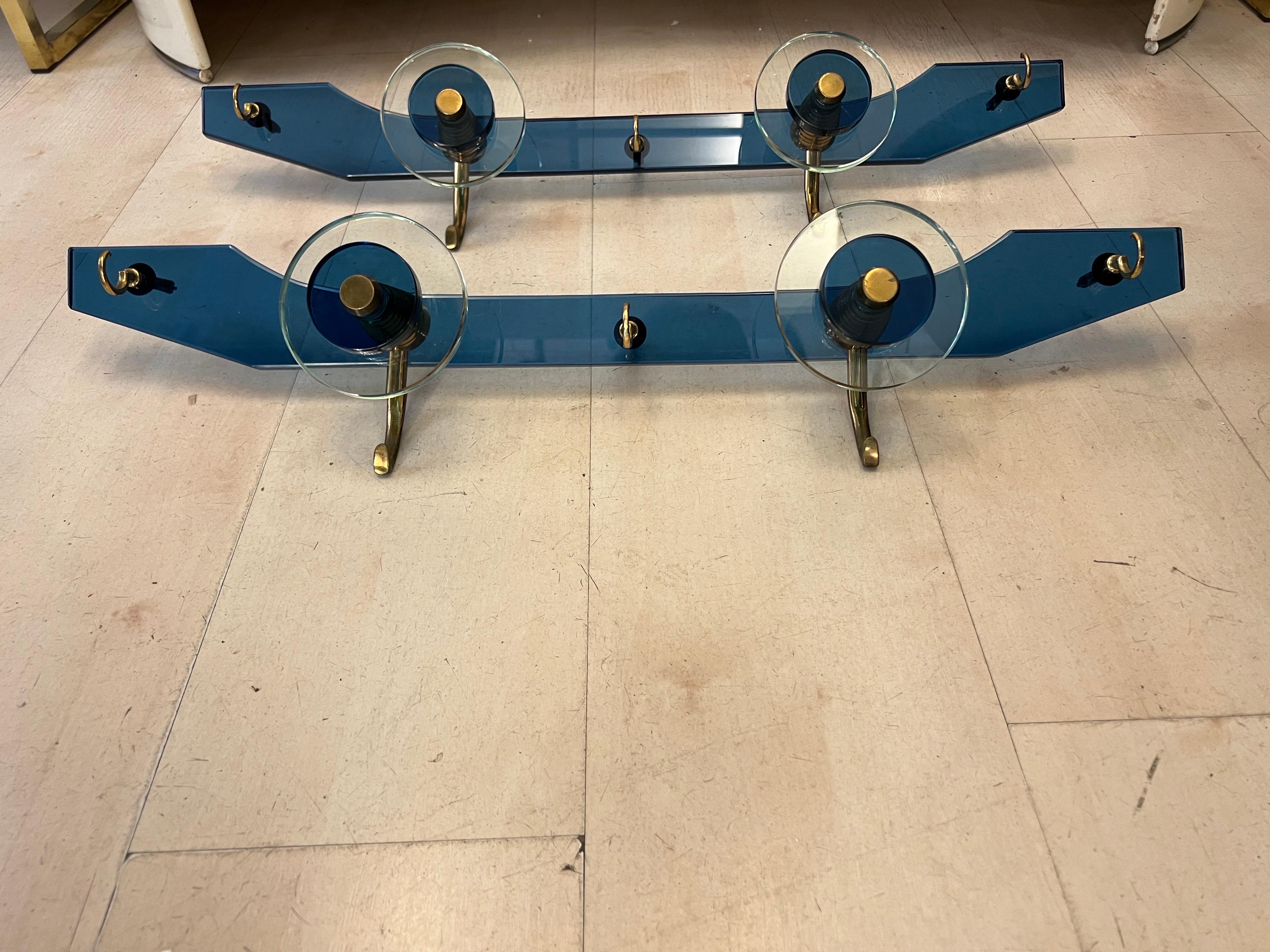 Pair of Vintage Blue and Clear Murano Glass Coat Hangers with brass details.
The Murano Glass is in perfect condition, the metal is original of the period and thus shows normal signs of age and use.
Can be sold individually.