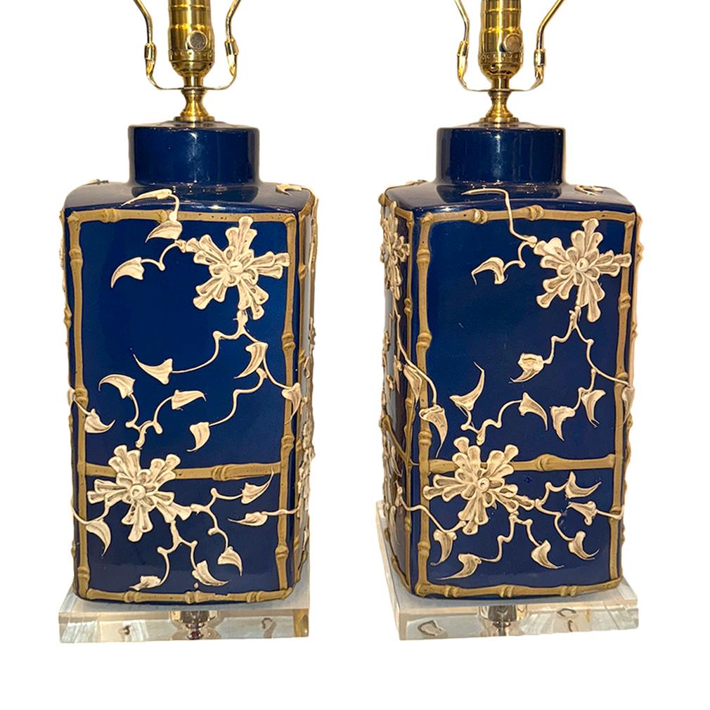 Pair of 1960's American blue porcelain lamps with applied foliage decoration.

Measurements:
Height of body: 15