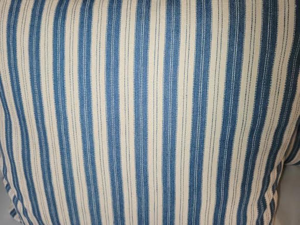 Pair of vintage blue and white ticking pillows. Linen backing and zippered casing.
