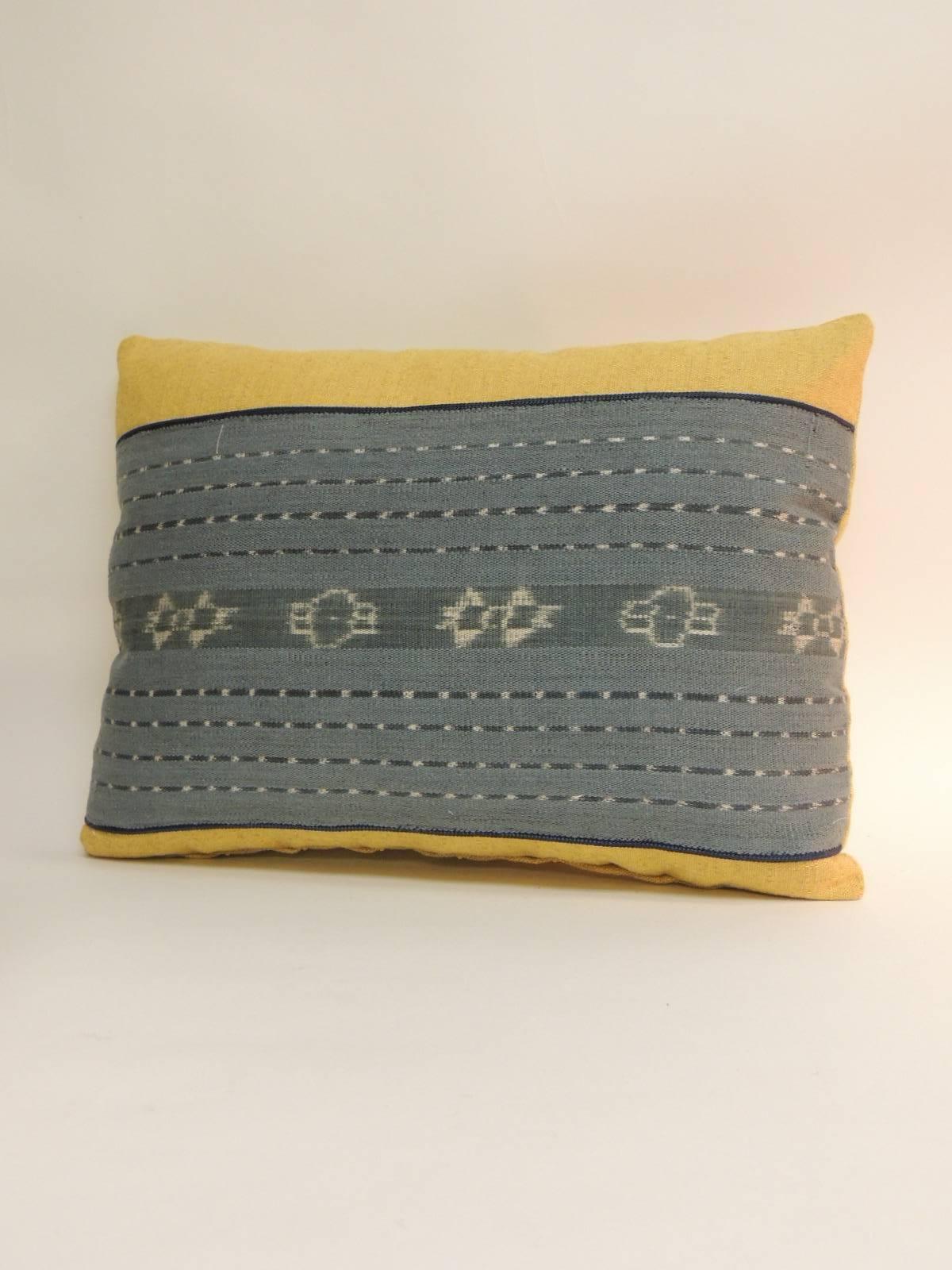 Pair of vintage white and blue tribal vintage textile designed decorative pillows. Woven antique textile center panel framed with heavy yellow linen same as backing. Throw bolster Ikat pillows embellished with a small silk custom-made rope trim.