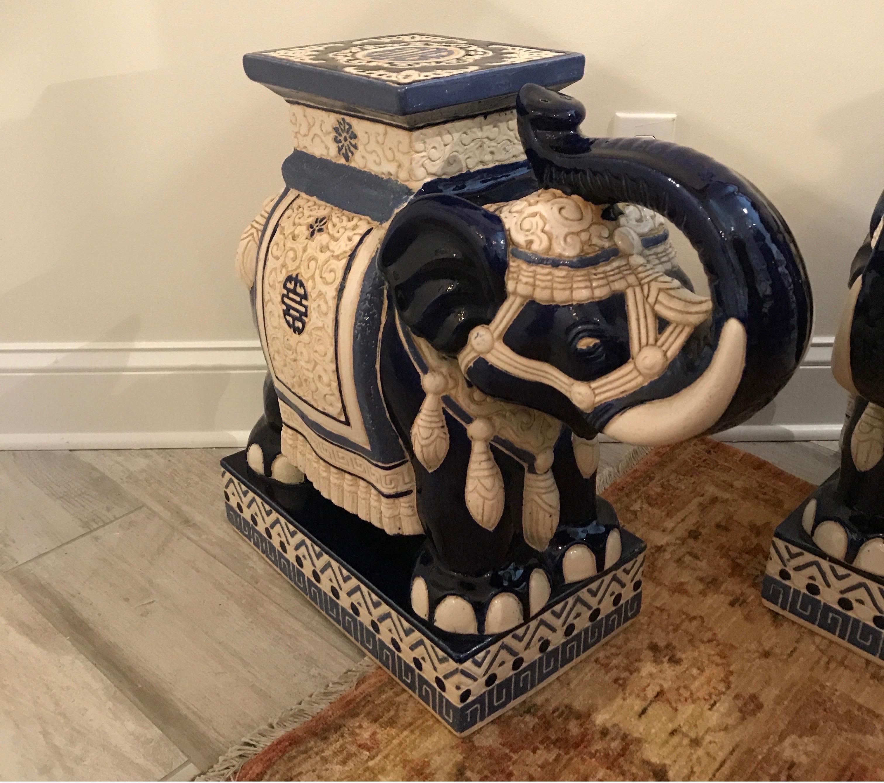 Imperial pair of vintage blue and white terracotta elephant garden seats / side tables with their trunks in the up position.