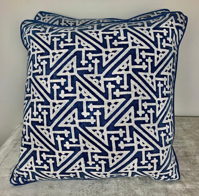 Pair of pillow made with vintage blue and white printed Fortuny cotton fronts and dark blue linen backs. Self-cord detail, down inserts, sewn closed.