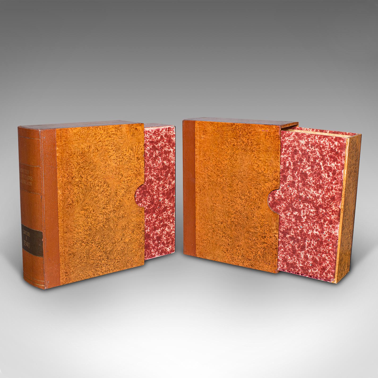This is a pair of vintage book boxes. An English, leather-bound secret safe or folio storage, dating to the mid 20th century, circa 1950.

Keep unwanted attention away with this pair of concealed storage boxes
Displays a desirable aged patina and