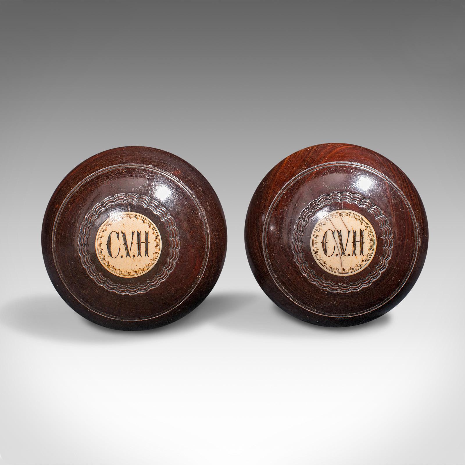 This is a pair of vintage bowling woods. A Scottish, hardwood lawn bowls ball by Thomas Taylor of Glasgow, dating to the mid 20th century, circa 1935.

Fascinating pair of numbered and monogrammed woods
Displaying a desirable aged and play-worn