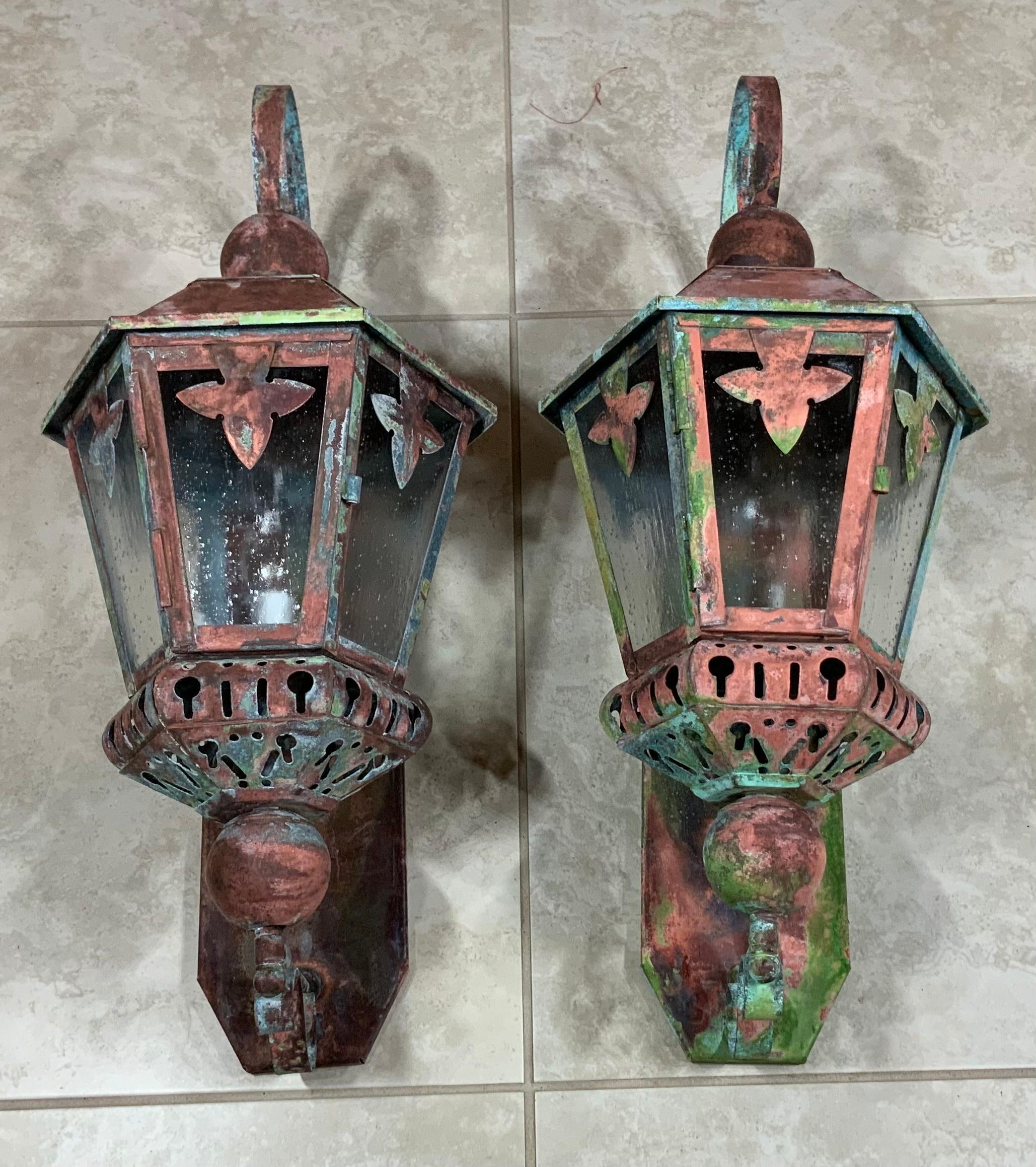 Artistically made vintage hand crafted solid brass and copper lantern with one 60/watt light , seeded acrylic glass like at all side , with beautiful patina.
Great decorative pair of lights outdoor or indoor.