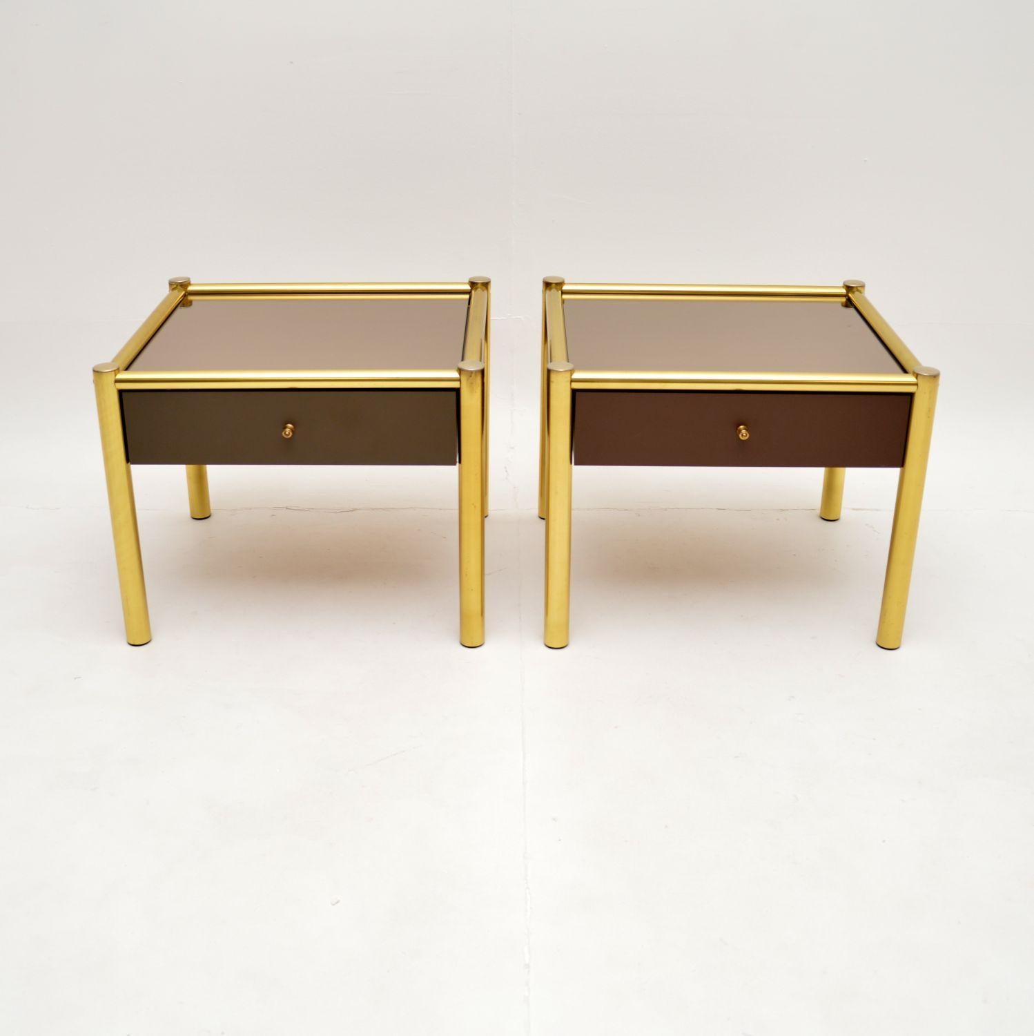 A stylish and very well made pair of vintage brass and glass side tables. They were made in France, they date from around the 1970’s.

They are very well made, the frames are actually brass plated aluminium, with mirrored glass tops. Each has a