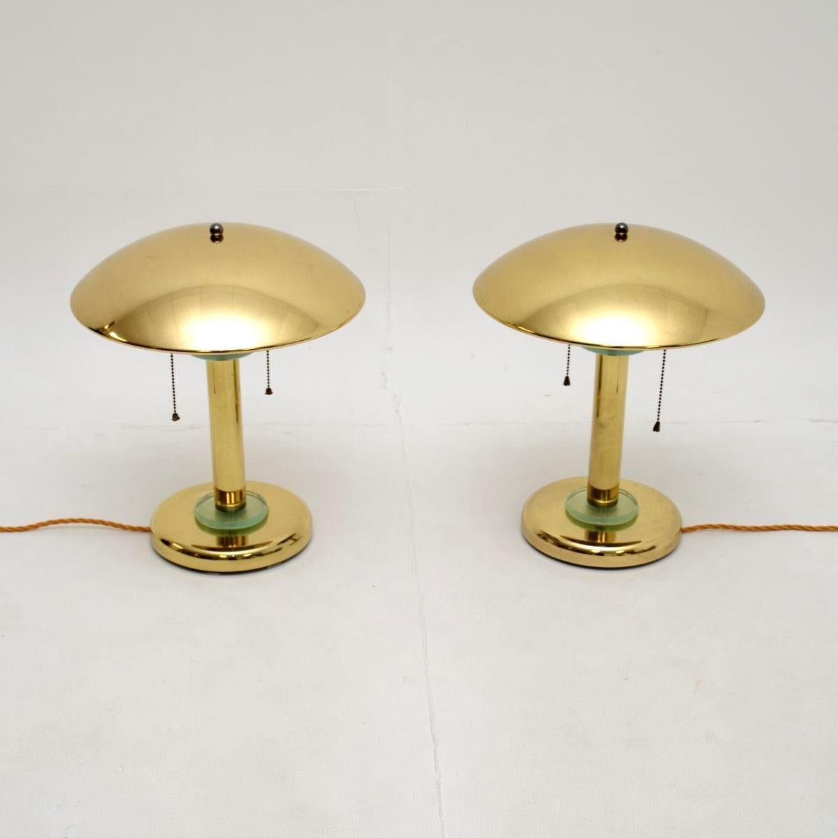 A stunning pair of vintage brass and glass table lamps, made in France and dating from around the 1970’s.

They are of superb quality, in the classic Art Deco style. They have a mushroom shaped design, with beautiful glass accents at the bases and