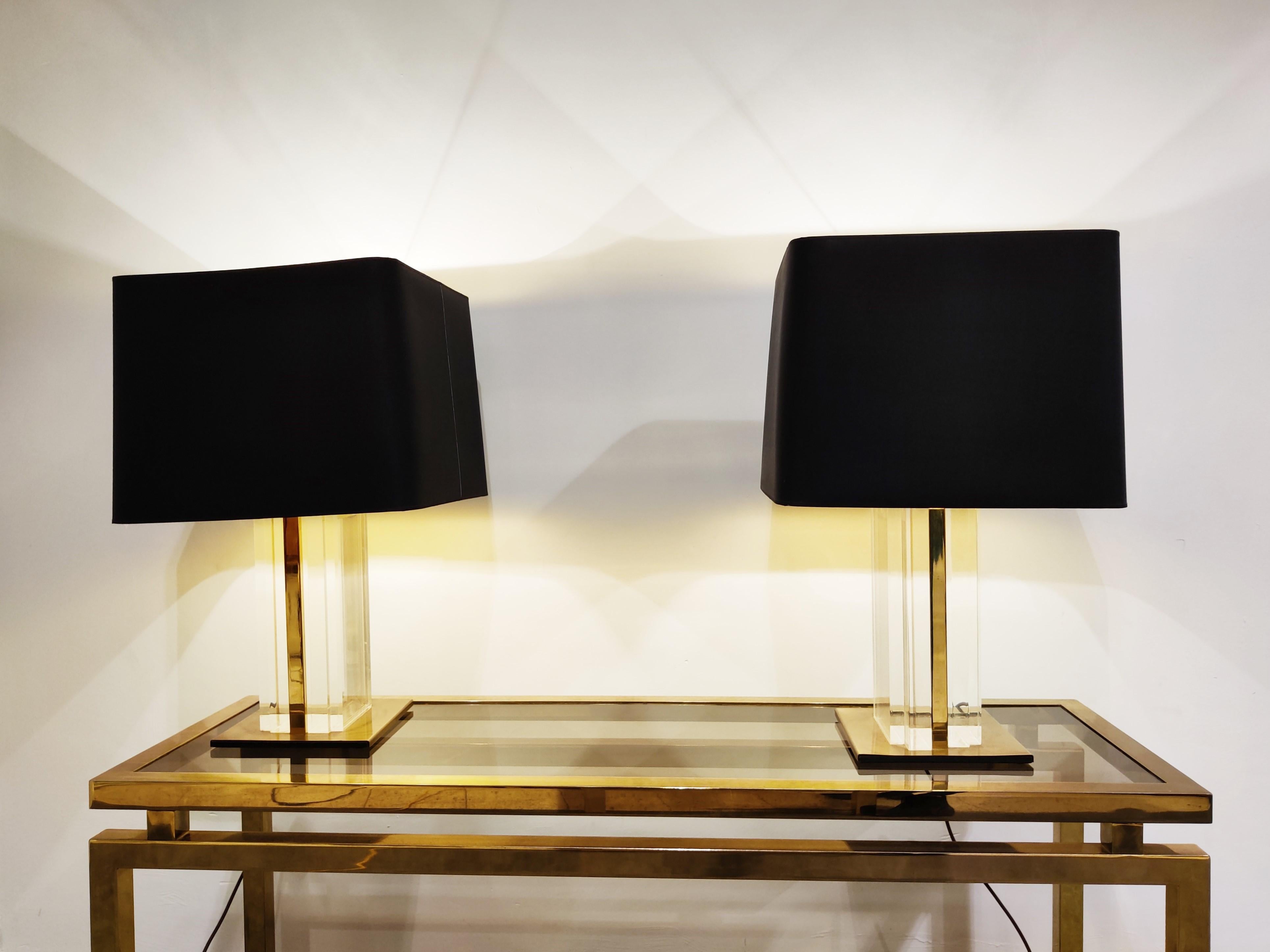 Pair of eye-catching brass and Lucite table lamps by Belgochrom.

The table lamps come with their original black lamp shades.

The lamps are quite large, and as a pair they make a great statement piece on a credenza or side tables.

Good