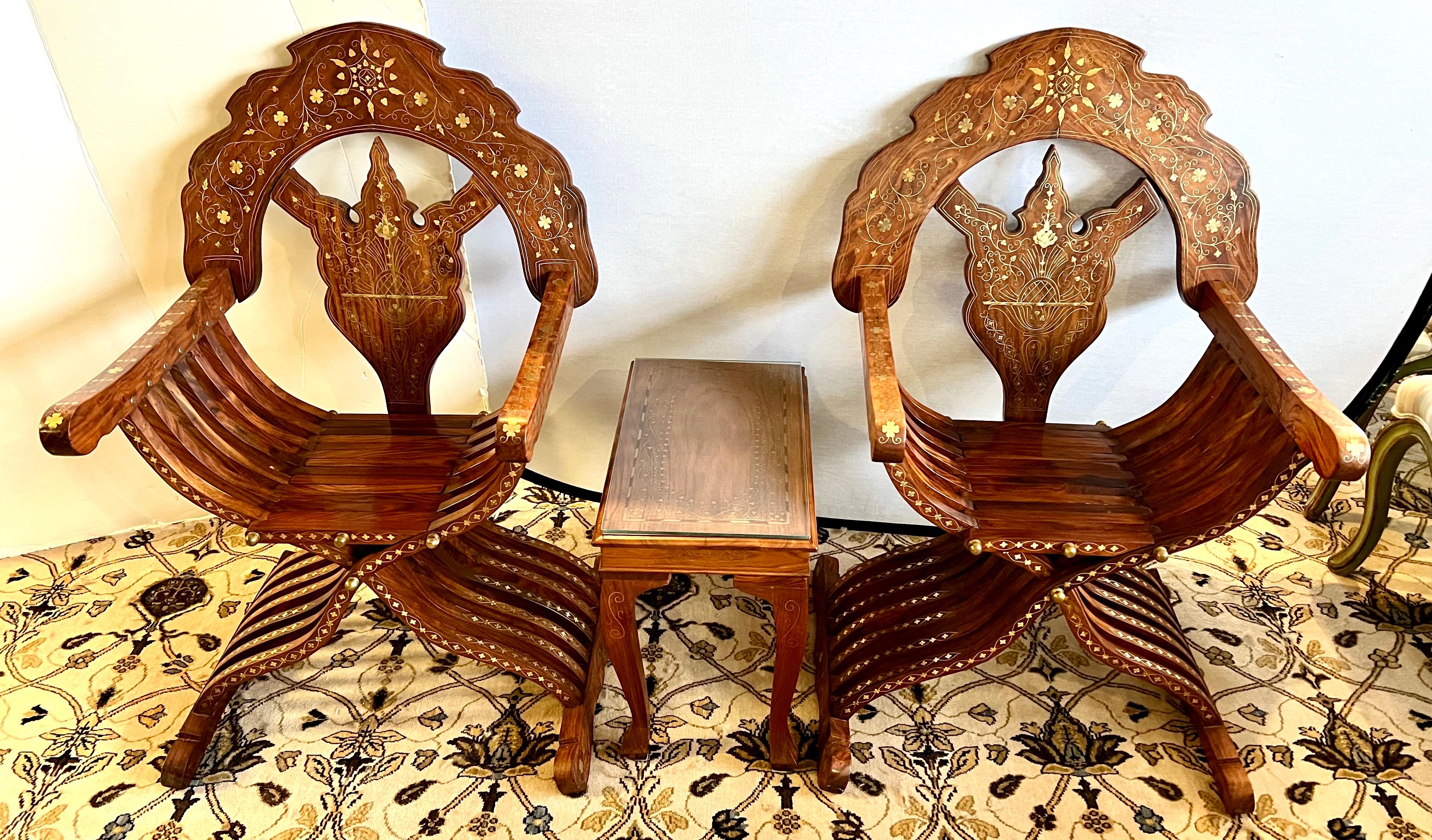 Stunning Savonarola chairs with intricate brass inlay of flowers and scrollwork on the backs, arms and legs. 
The chairs have metal rods to the seat which can be removed and then the chairs can be folded.
The table has equally stunning brass