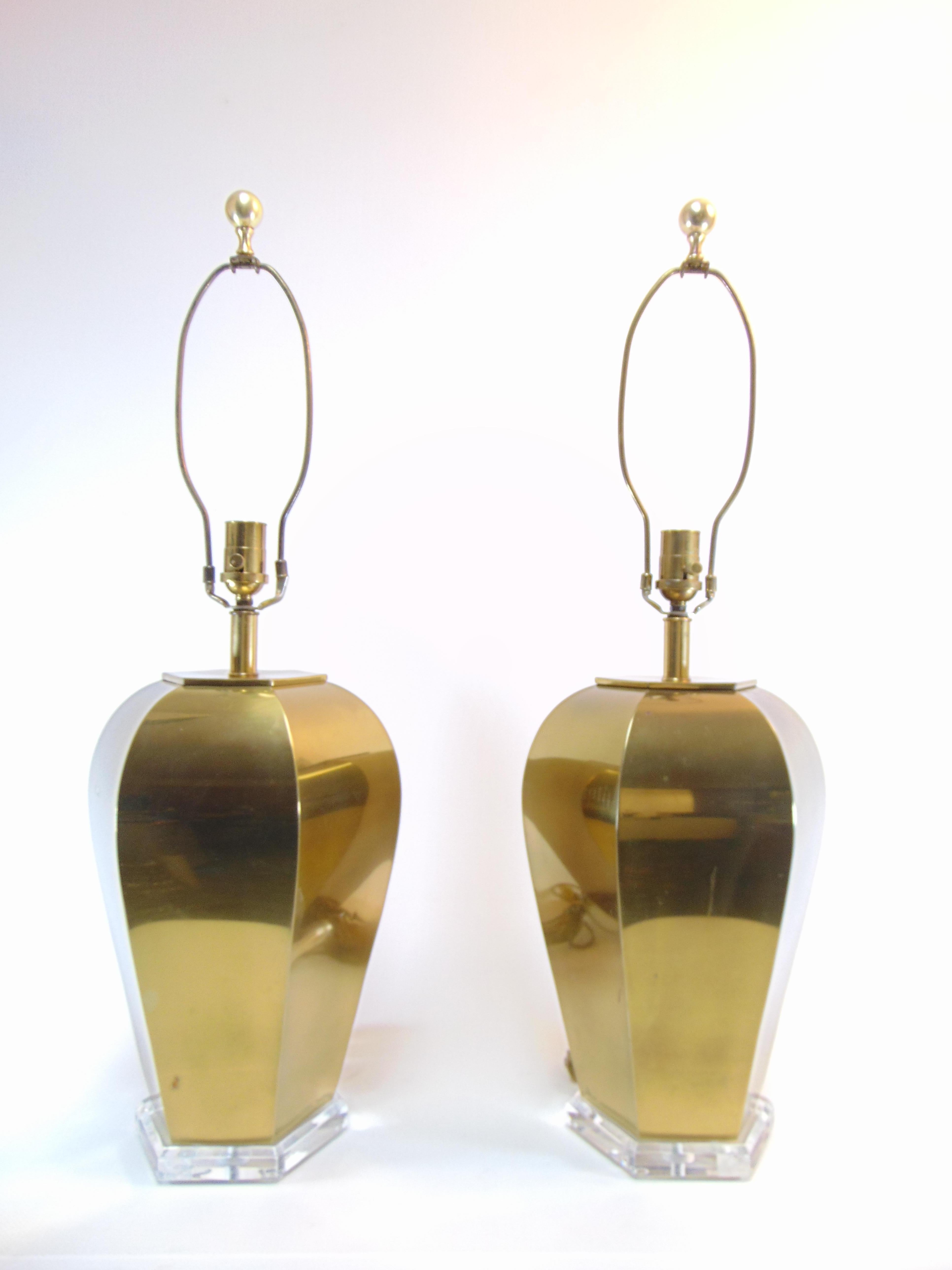Classic pair of brass table lamps from the 1980s resting upon beveled Lucite octagonal bases. These lamps are manufactured by Remington.
Dimensions are:
11” W
31.5” H
21” height to bulb
7” diameter of the base.