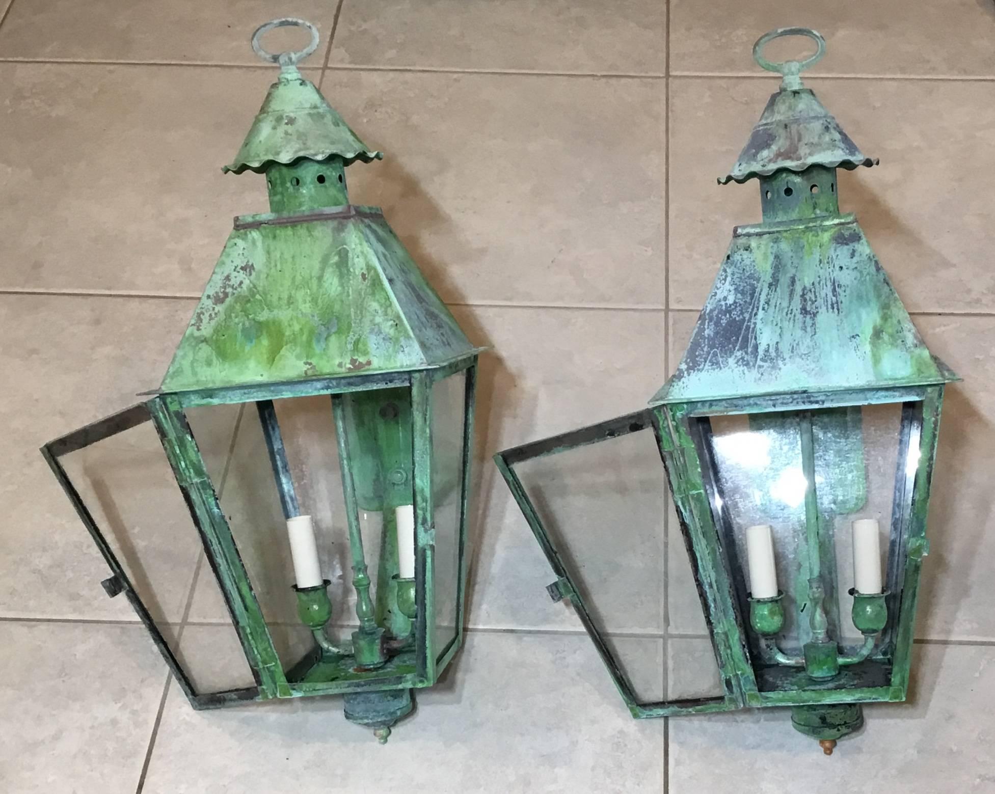 Pair of vintage lanterns made of brass with beautiful weathered patina ,two 60/watt light in each lantern electrified and ready to use .