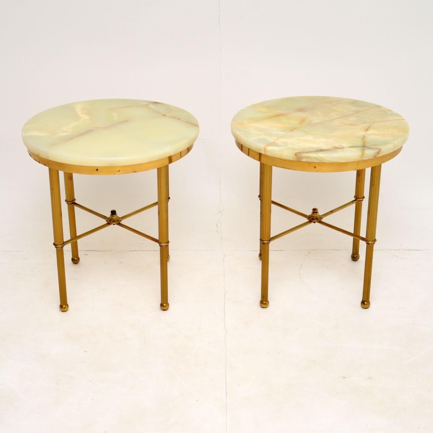 A gorgeous pair of vintage side tables, dating from the 1950-60’s, these were made in France.

They have a beautiful design, the solid brass frames have X frame stretchers and fluted legs.

The brass is in excellent condition for its age, with