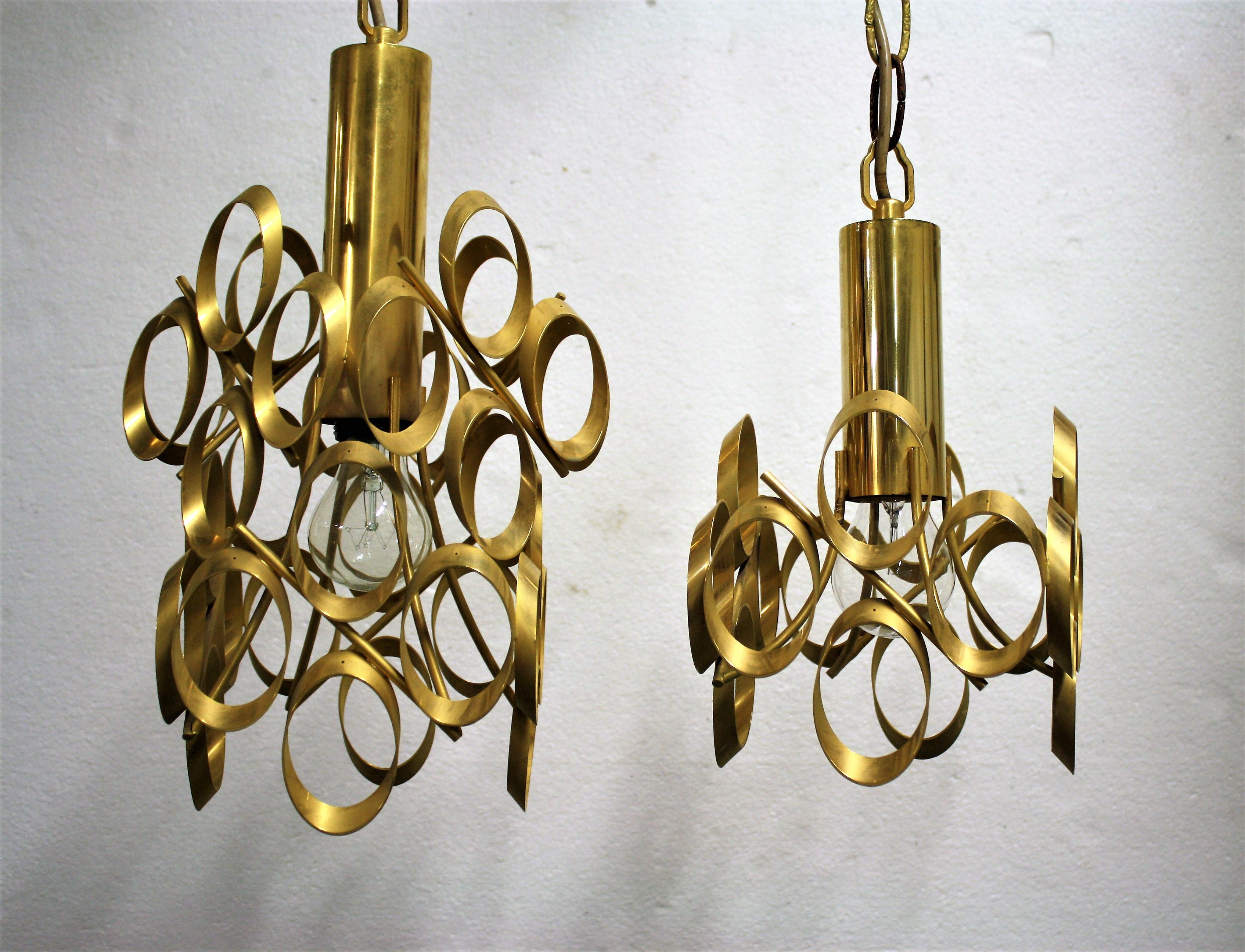 A pair of brass ring pendant lights design by Gaetano Sciolari.

These unique pendant lights are rare and come as a pair.

They can be hung together above a table or counter at a different height to create the best effect.

These well designed