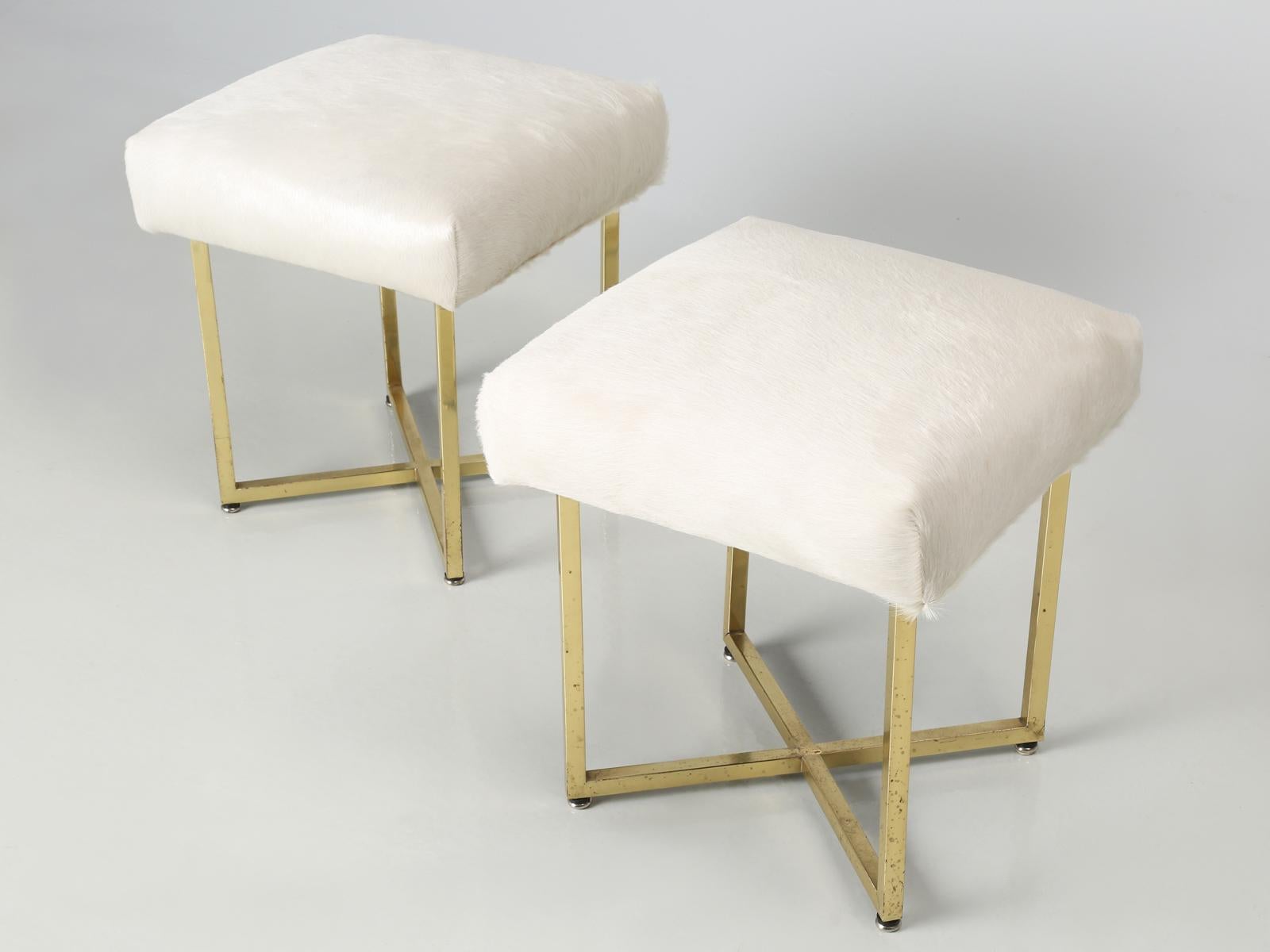 Pair of brass stools attributed to Paul McCobb and upholstered in Moore and Giles hair on hide. Please note that the brass legs are not perfectly straight and have quite a heavy patina. Please pay close attention to all detail photos.
 