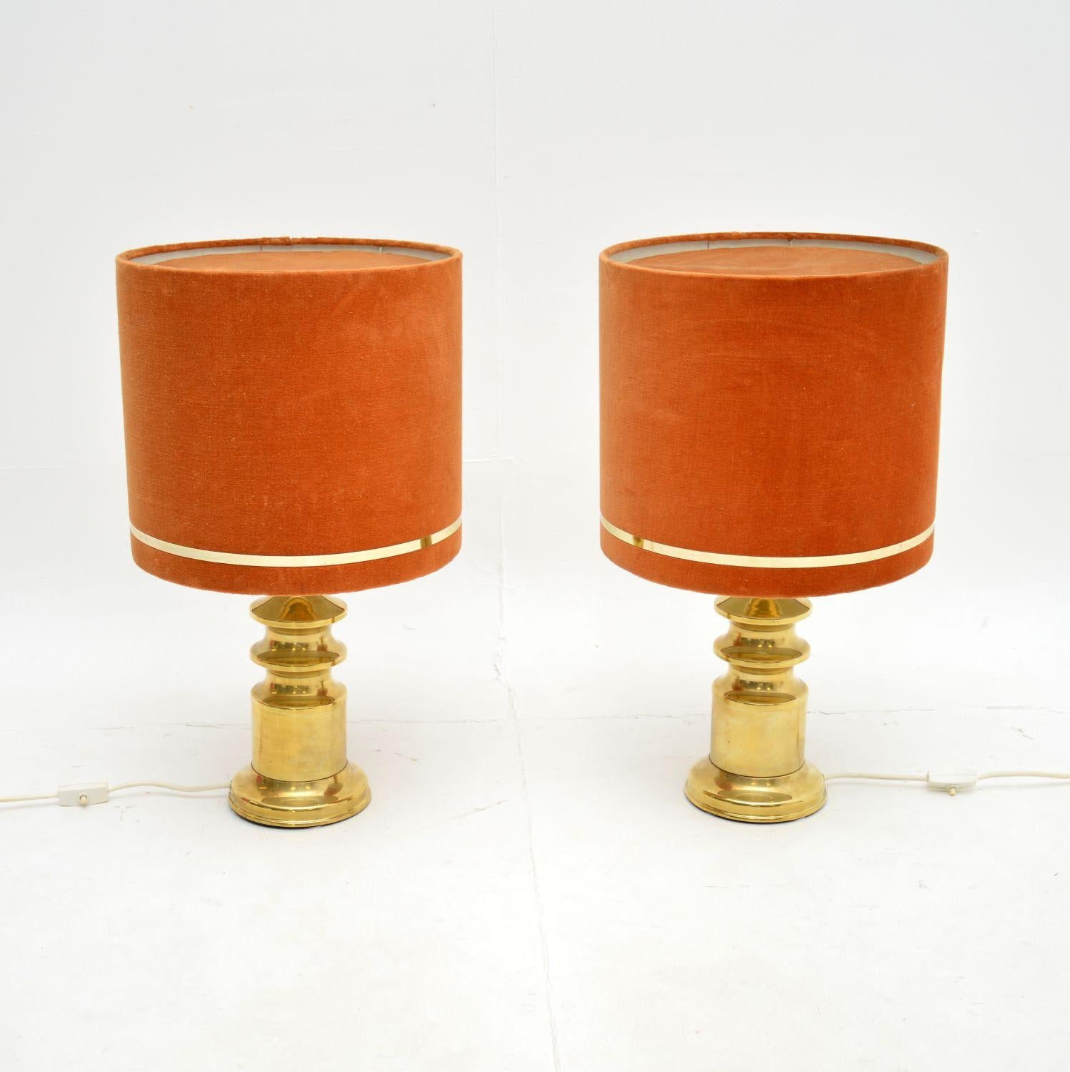 A beautiful pair of vintage brass table lamps with velvet shades. They were made in France, and they date from the 1970’s.

The quality is lovely, the solid brass lamp stands are beautifully made and have a bold design. They come with original