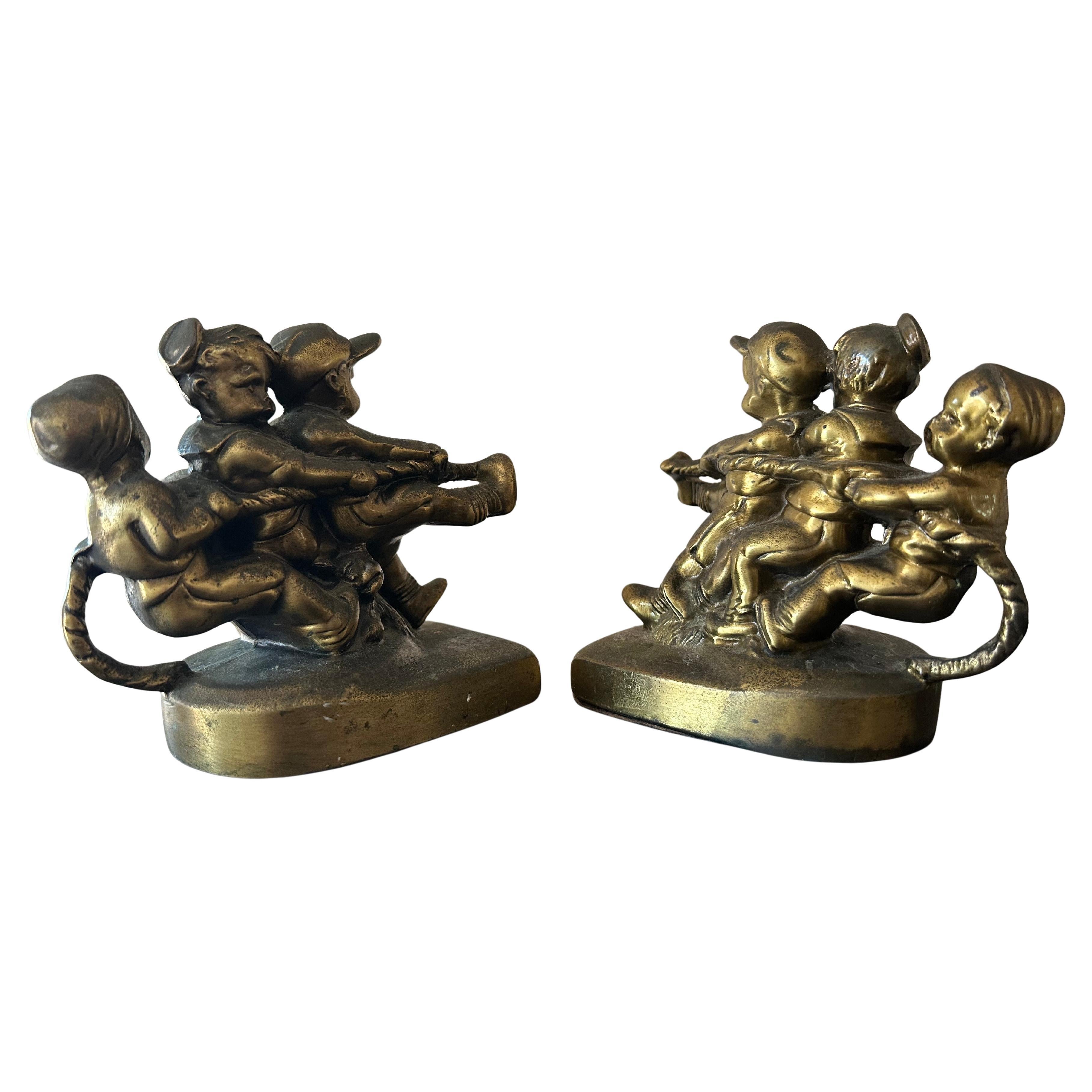 Dieses skurrile Paar Messing-Buchstützen mit Kindern (und Hund) beim Tauziehen von P.M. Craftsman (Philadelphia Manufacturing Co.), ca. 1970er Jahre.  Das Set ist in sehr gutem Vintage-Zustand und misst ungefähr 5,25 