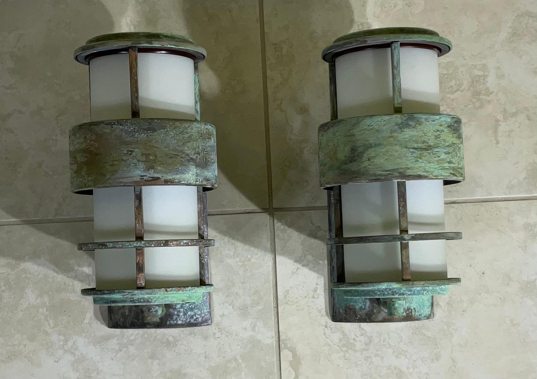 Elegant pair of sconces made of solid brass frame with milk glass tube in the center reflecting 60/watt light each sconces.
Great decorative modern light for indoor or outdoor int the front of the house.