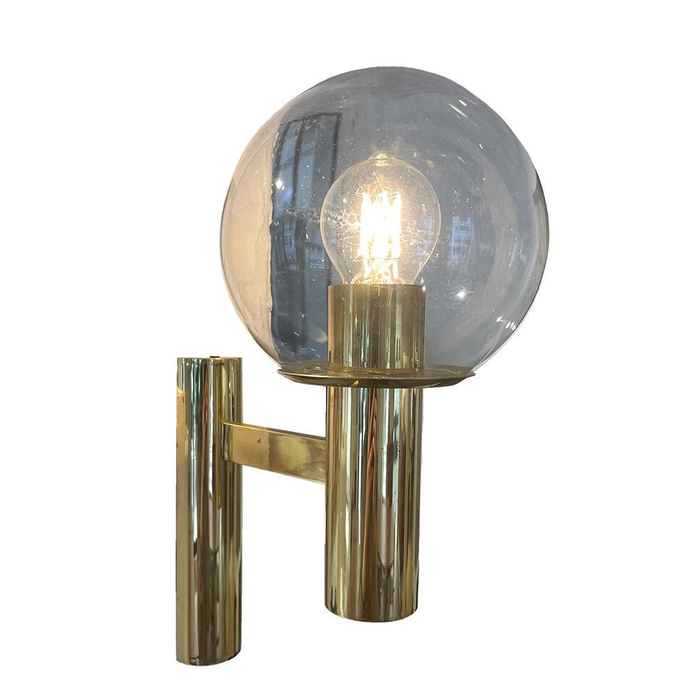Pair of very elegant wall lights. Model designed in the 1960s. Structure of the brass wall lights and transparent glass globes which apply finely and easily to the bulb. Clean lines and finesse of execution. They diffuse a very pleasant light and