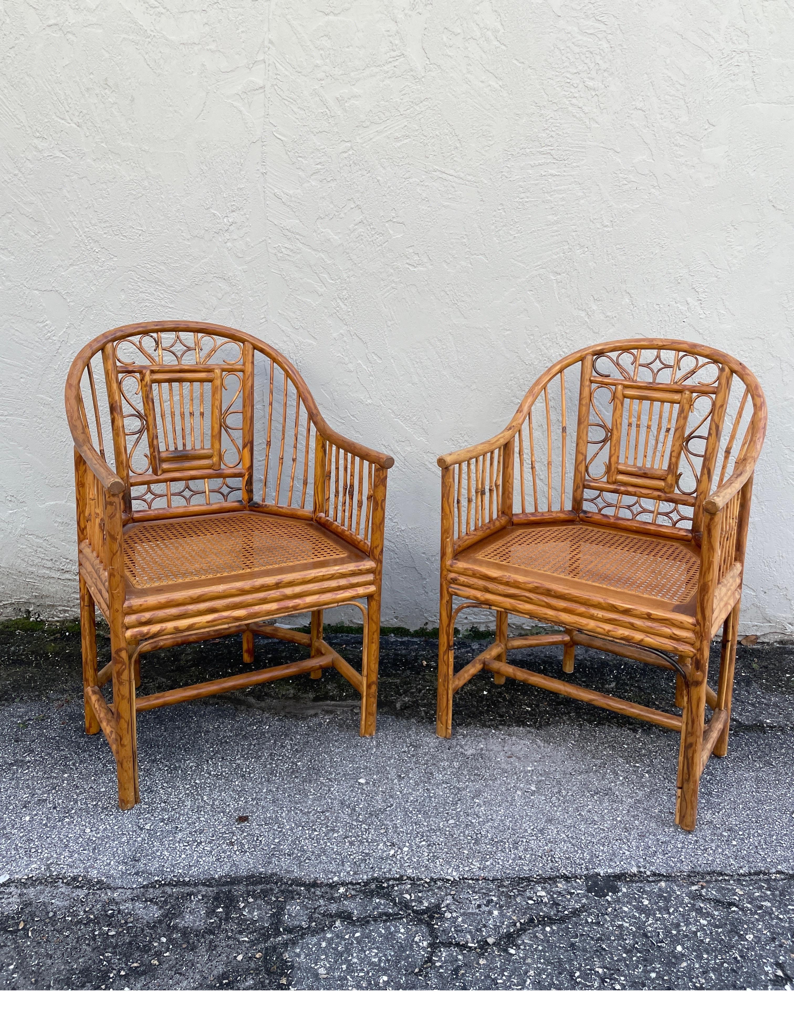 Vintage pair of burnt bamboo and rattan Brighton Pavilion armchairs with cane seats. These chairs are in very good condition.