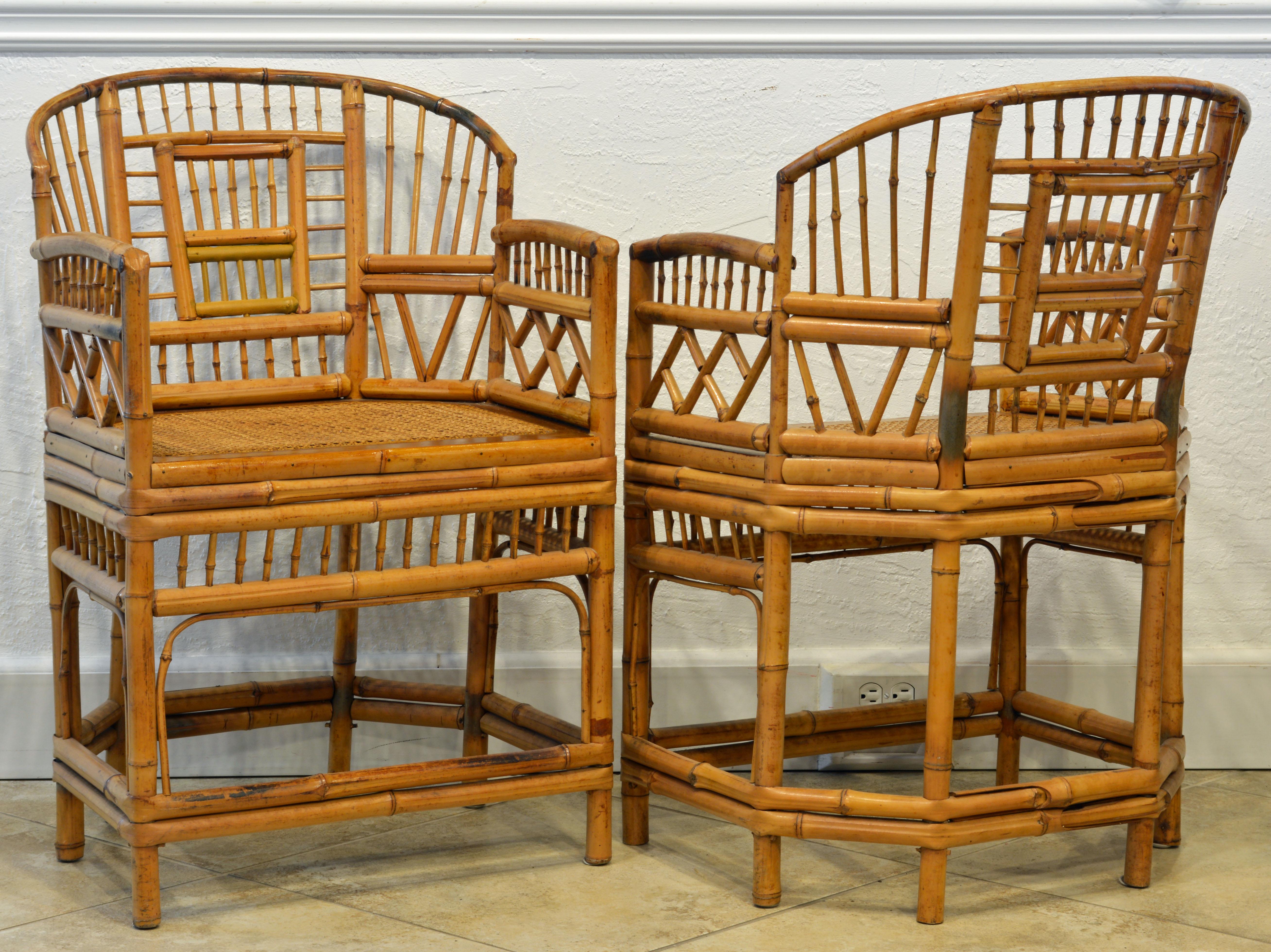 Rising on six legs these intricately crafted iconic armchairs with cane seats feature bamboo frames and Chinese themed bamboo open work inspired by Chippendale design.