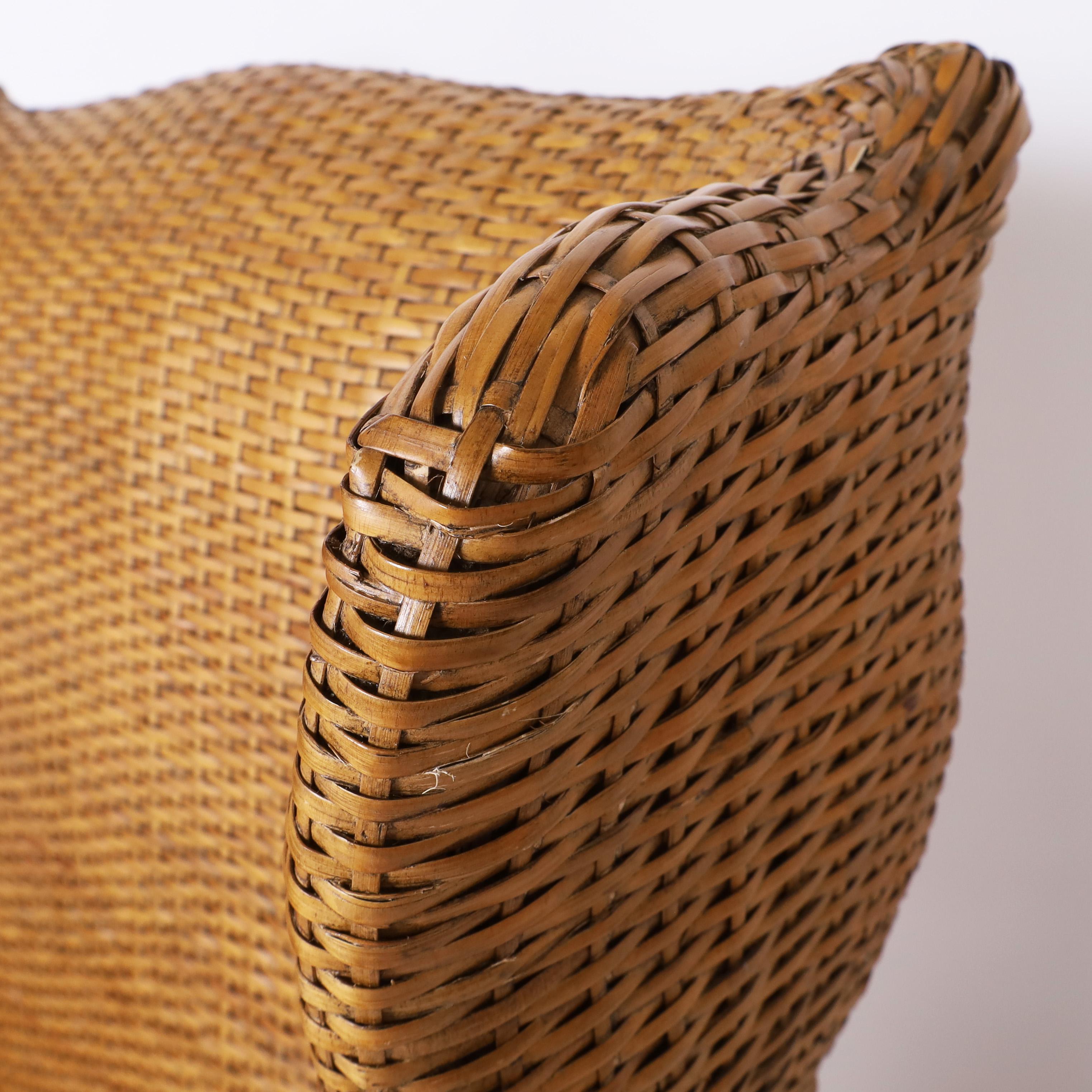 20th Century Pair of Vintage British Colonial Style Woven Reed Wingback Armchairs For Sale