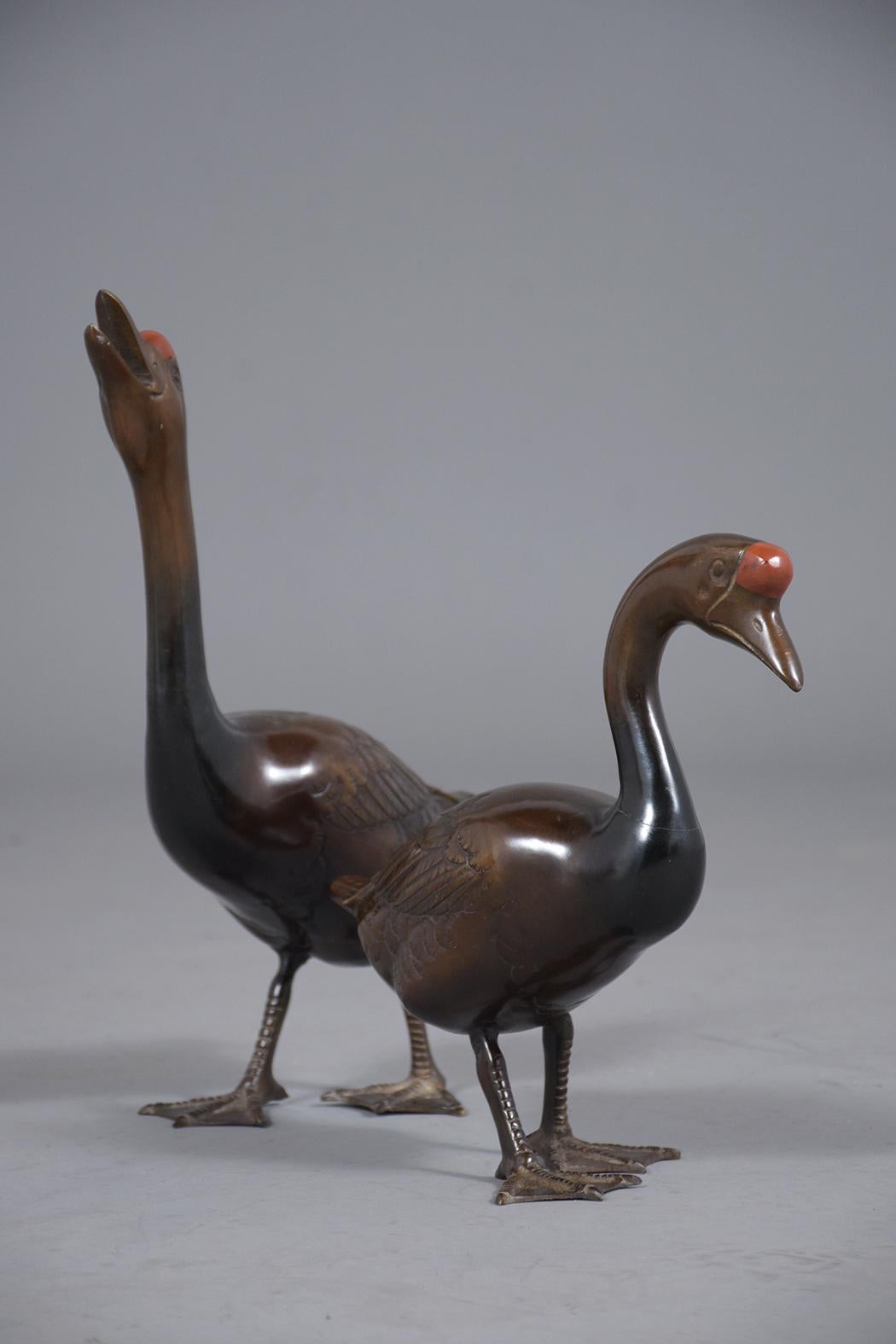 A pair of vintage Japanese bronze ducks from the mid-20th century are in great condition and can stand on their feet. This pair is ready to be placed anywhere in a home, indoors or outdoors. This pair of bronze standing ducks circa the 1930s have