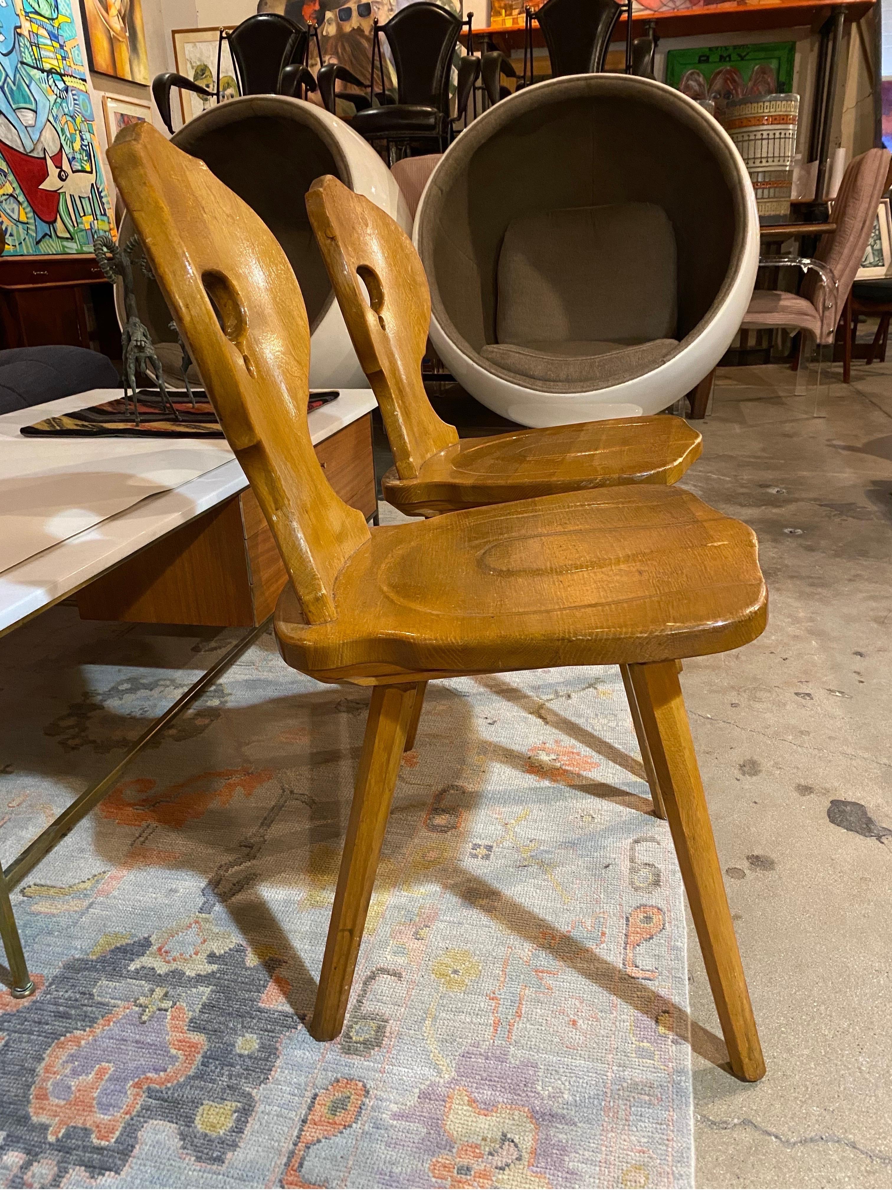 Pair of Mid-Century Modern blonde oak Brutalist chairs that feature a sculptural design and visible joints, Belgium, circa 1960s. Wear is age-appropriate and is in good overall condition.