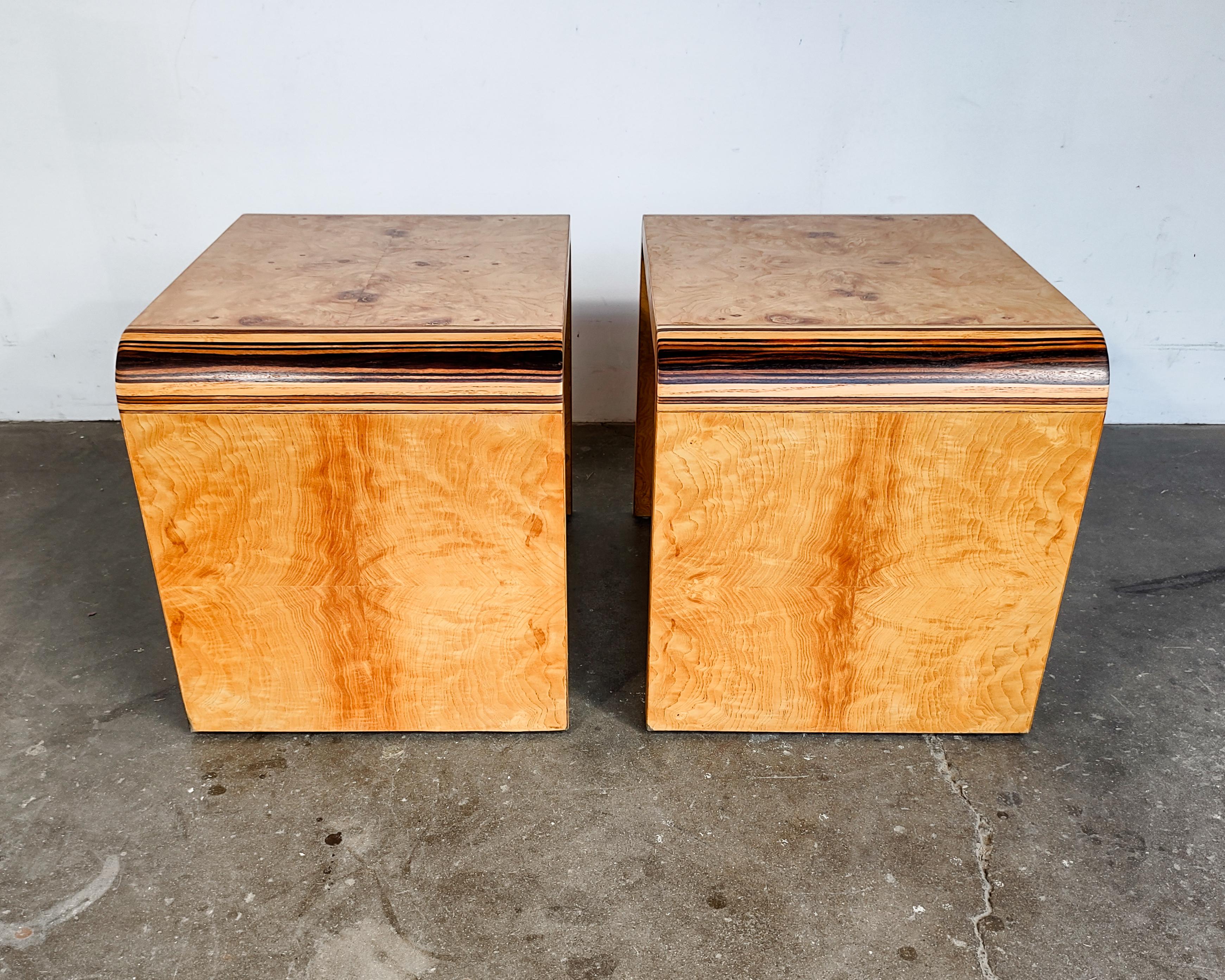Pair of burl waterfall side tables by Henredon. Refinished to showcase gorgeous olive burl wood grain with rosewood laminated corners. 

Measures: 21.5