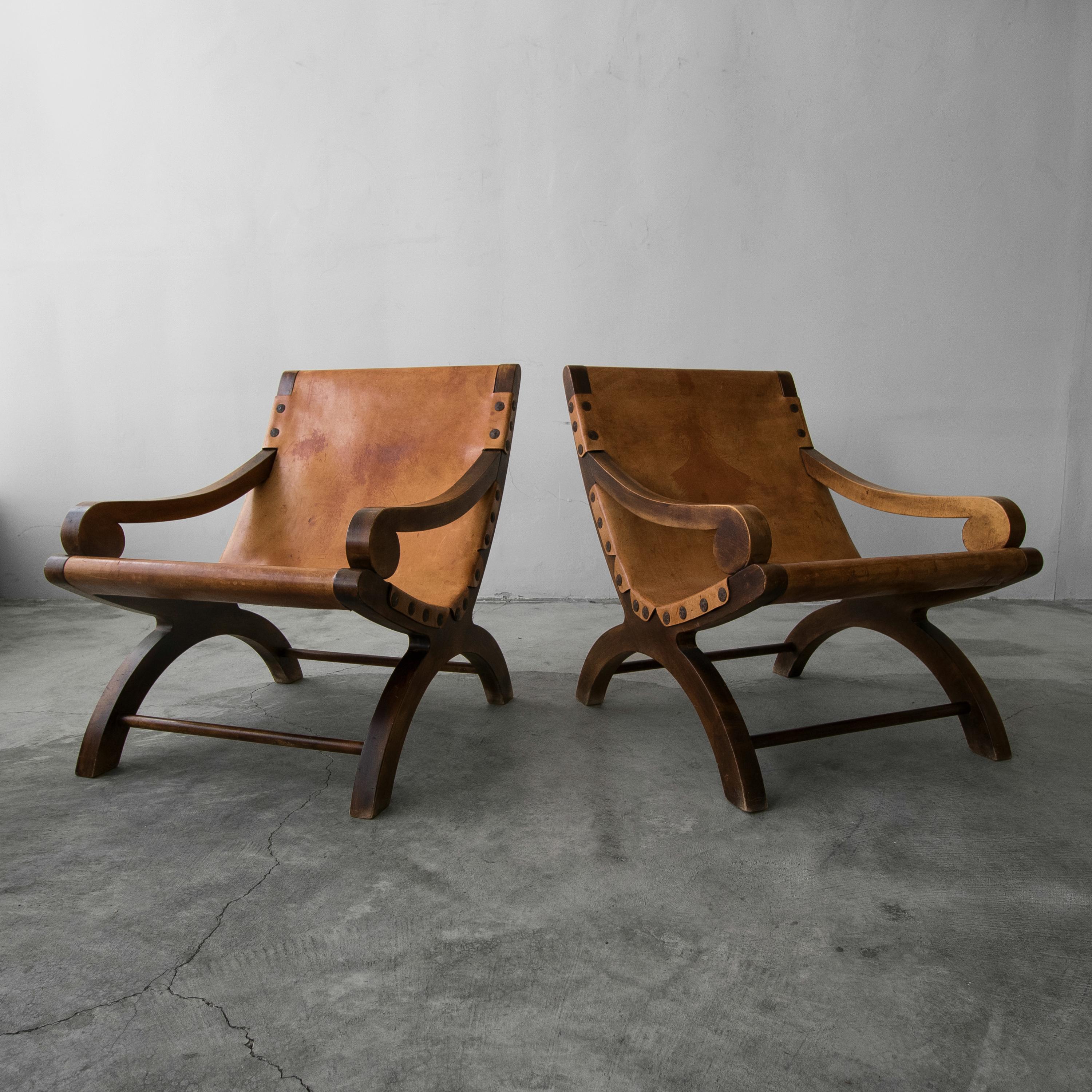 This pair of Butaque leather sling chairs is nothing short of amazing. Oversized and huge on character and style. These beauties are a site to behold. With all the amazing details of midcentury Mexican craftsmanship, combined with beautifully