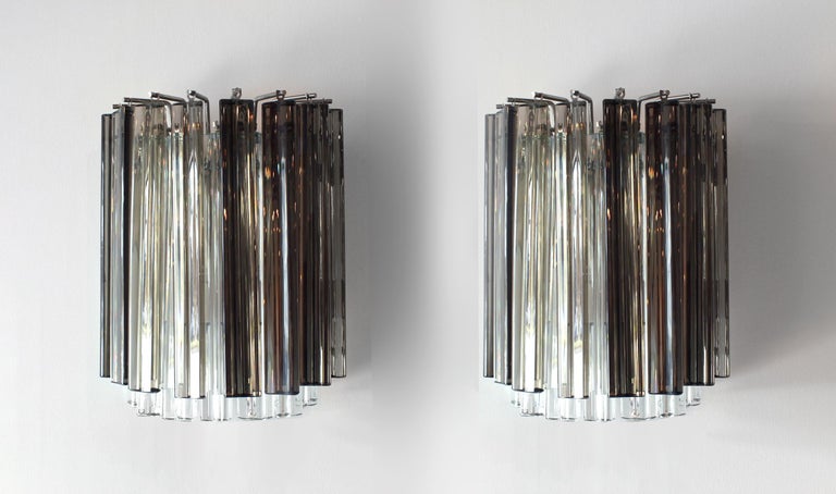 Pair of vintage smoked glass trihedron Camer sconces from the 1960s with brass back plate.