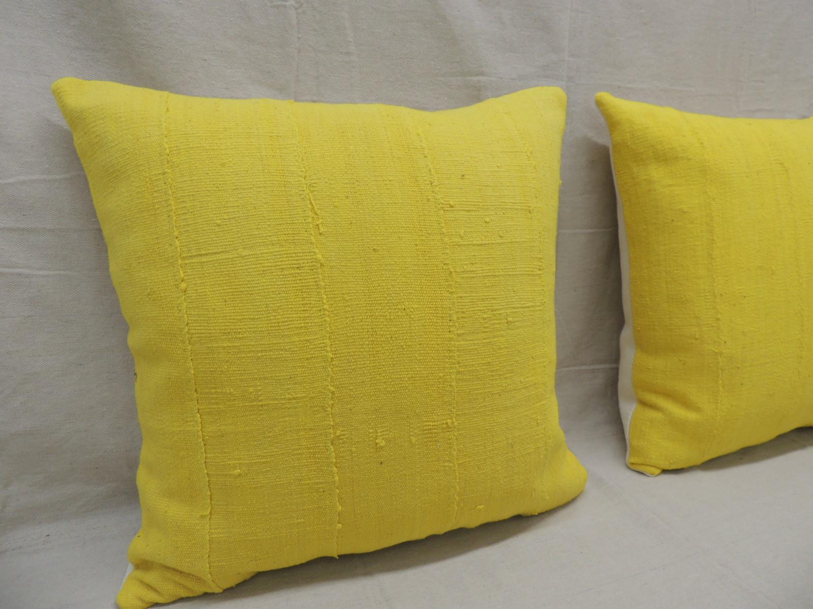 Pair of vintage canary yellow African mud cloth square decorative pillows
with textured white heavy linen backings.
Decorative pillow handcrafted and designed in the USA.
Closure by stitch (no zipper closure) with custom made pillow