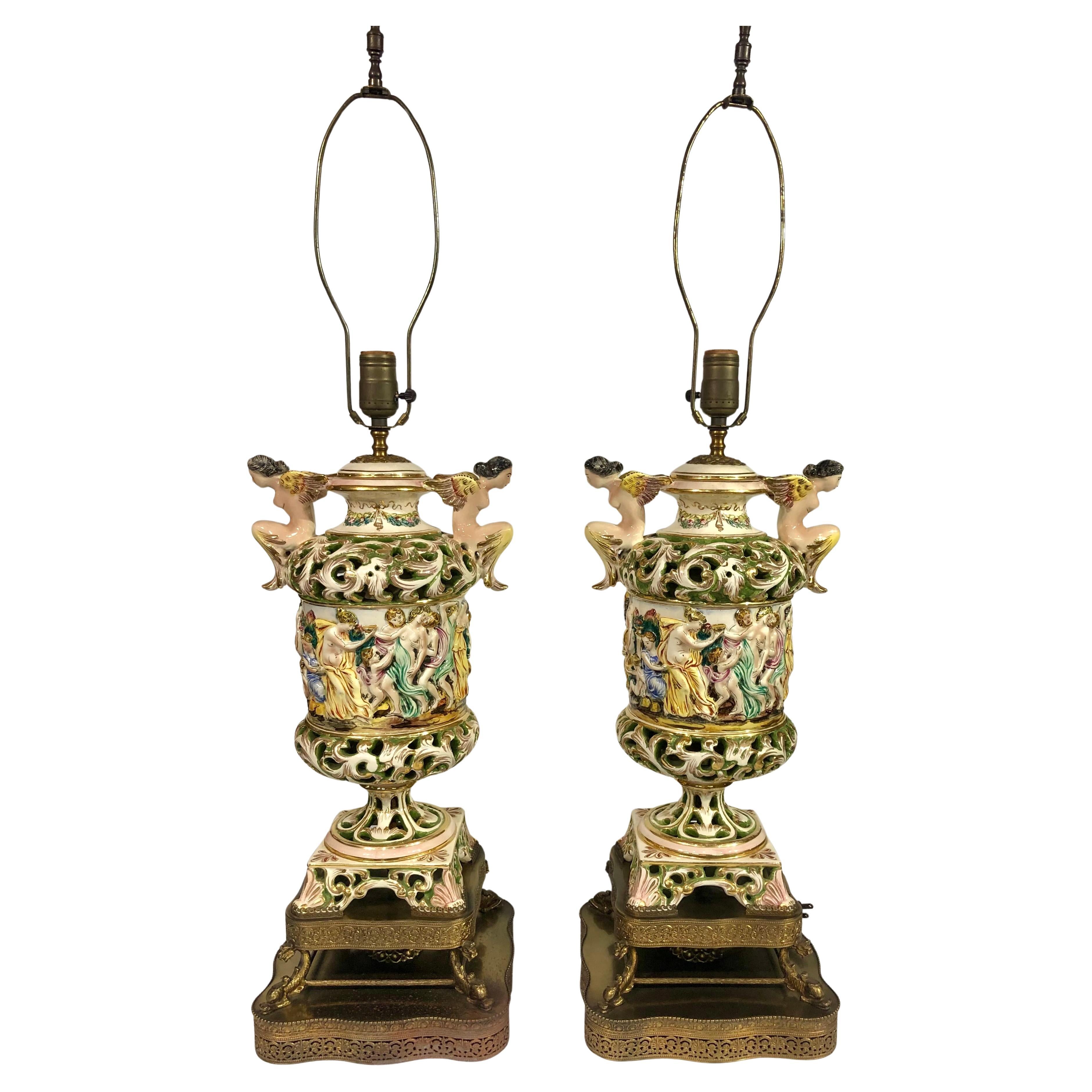 Pair of Vintage Capodimonte ceramic lamps with figurative bacchanal scene