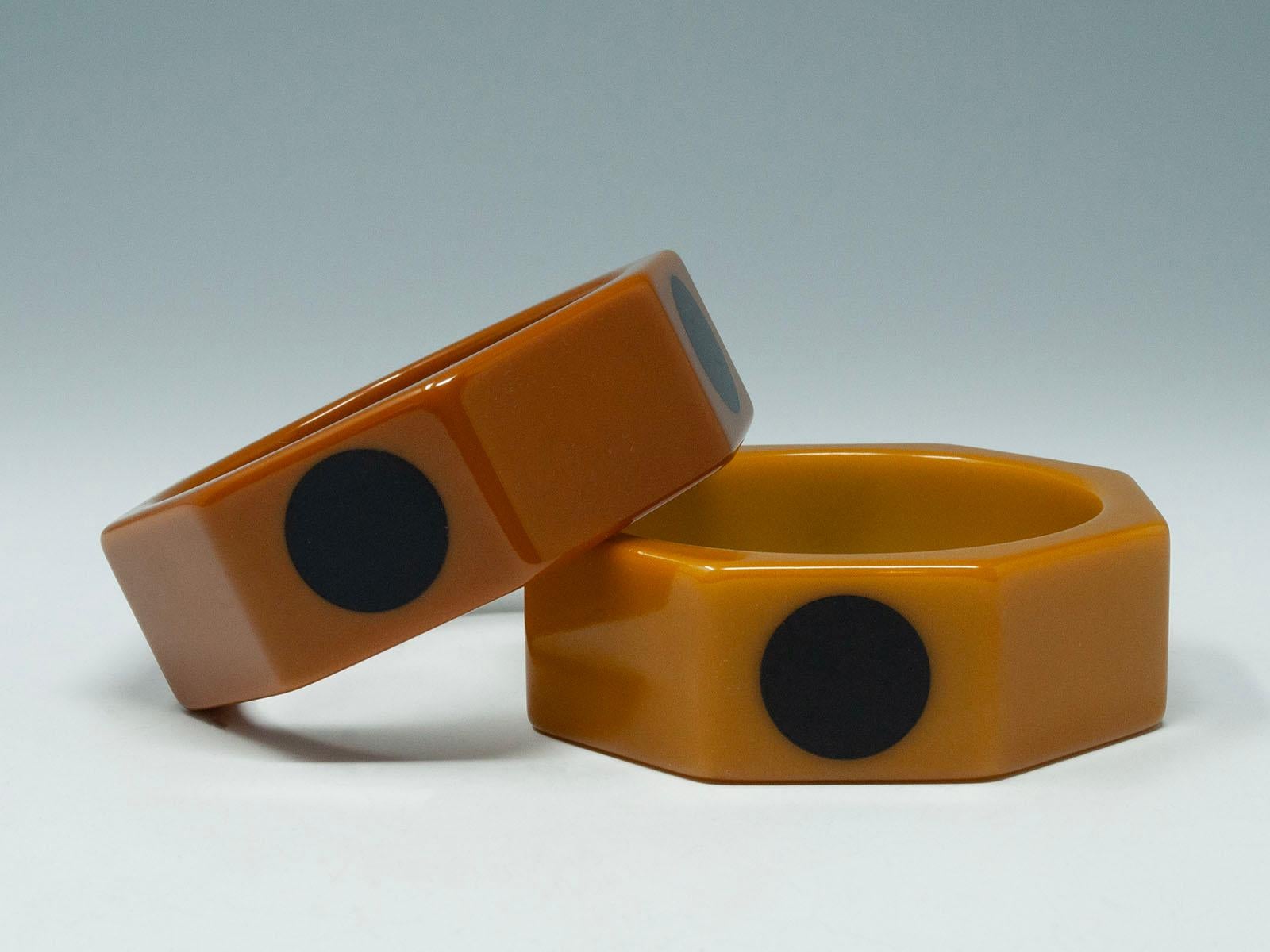 Pair of Vintage Caramel with Black Dots Bakelite Hexagonal Bangles

A delicious pair of vintage Bakelite bangles with a hexagonal shape in two different shades of caramel, with black dots on alternating facets. The interior diameter is 2.5 inches
