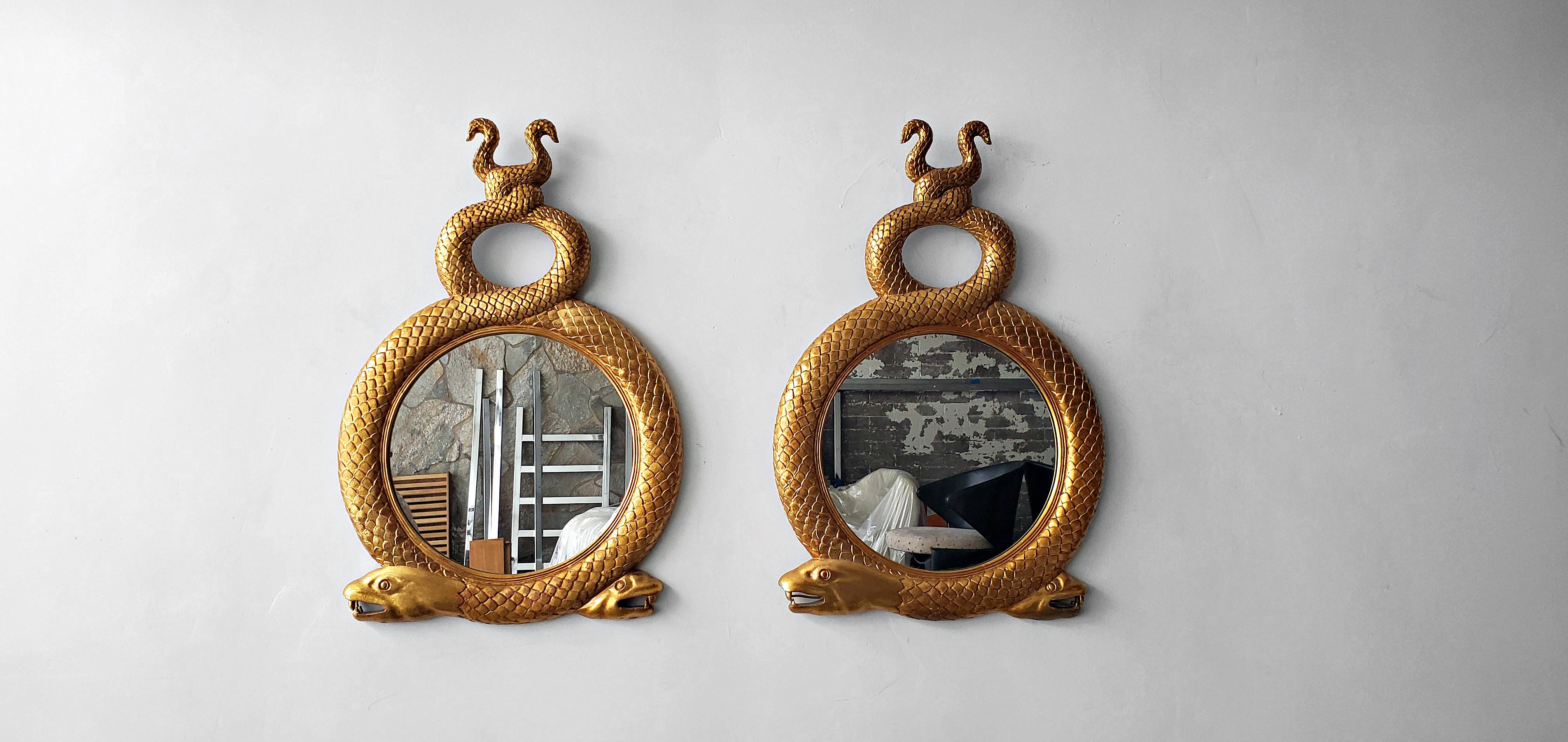 Absolutely stunning pair of vintage carved gilt serpent wall mirrors. A rare find but even rarer to find as a pair. They are carved from solid wood and gilded with amazing details.

Their uses are endless but my dream for the pair is to be used as