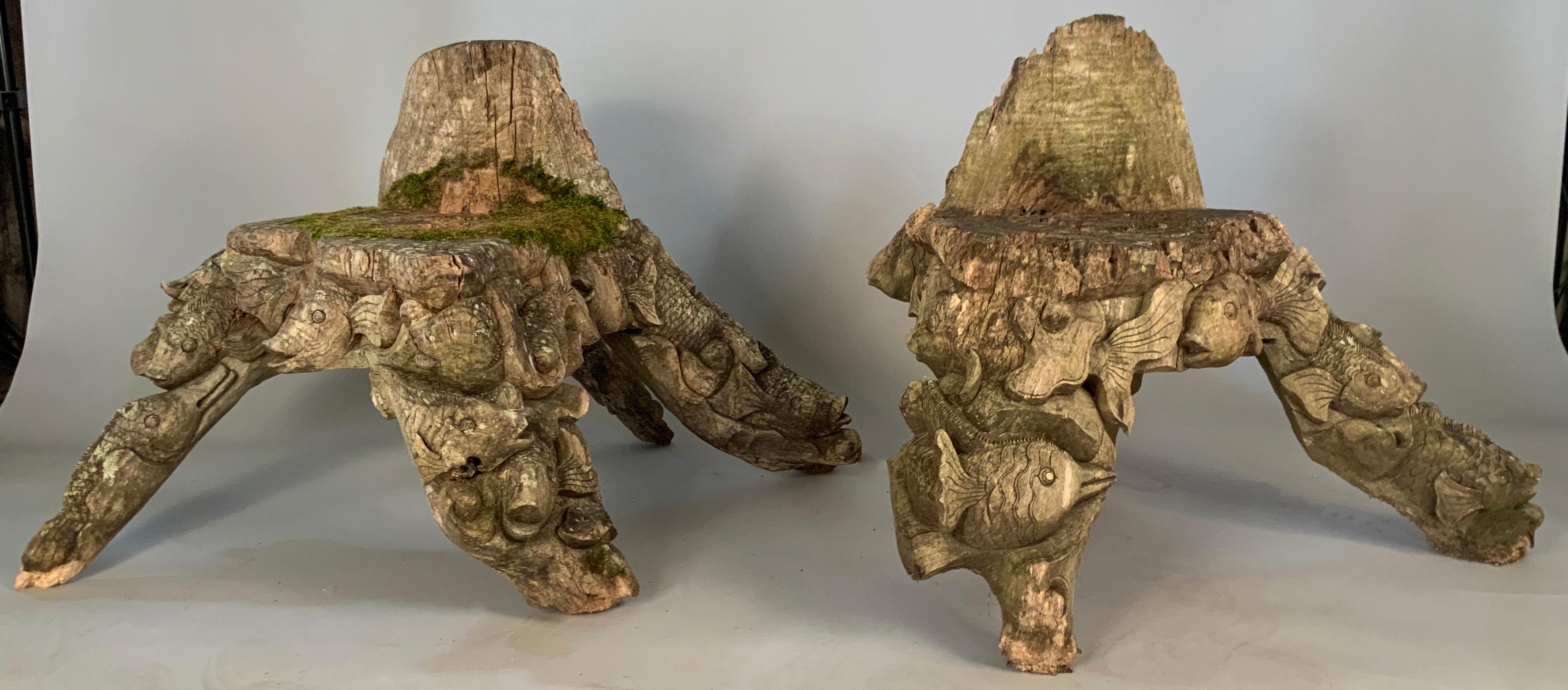 A pair of very unusual vintage mid-20th century carved wood chairs made with the forms of koi fish covering the legs and backs of the chairs, these are relics with an amazing amount of character, and although they are stable, they are not prepared