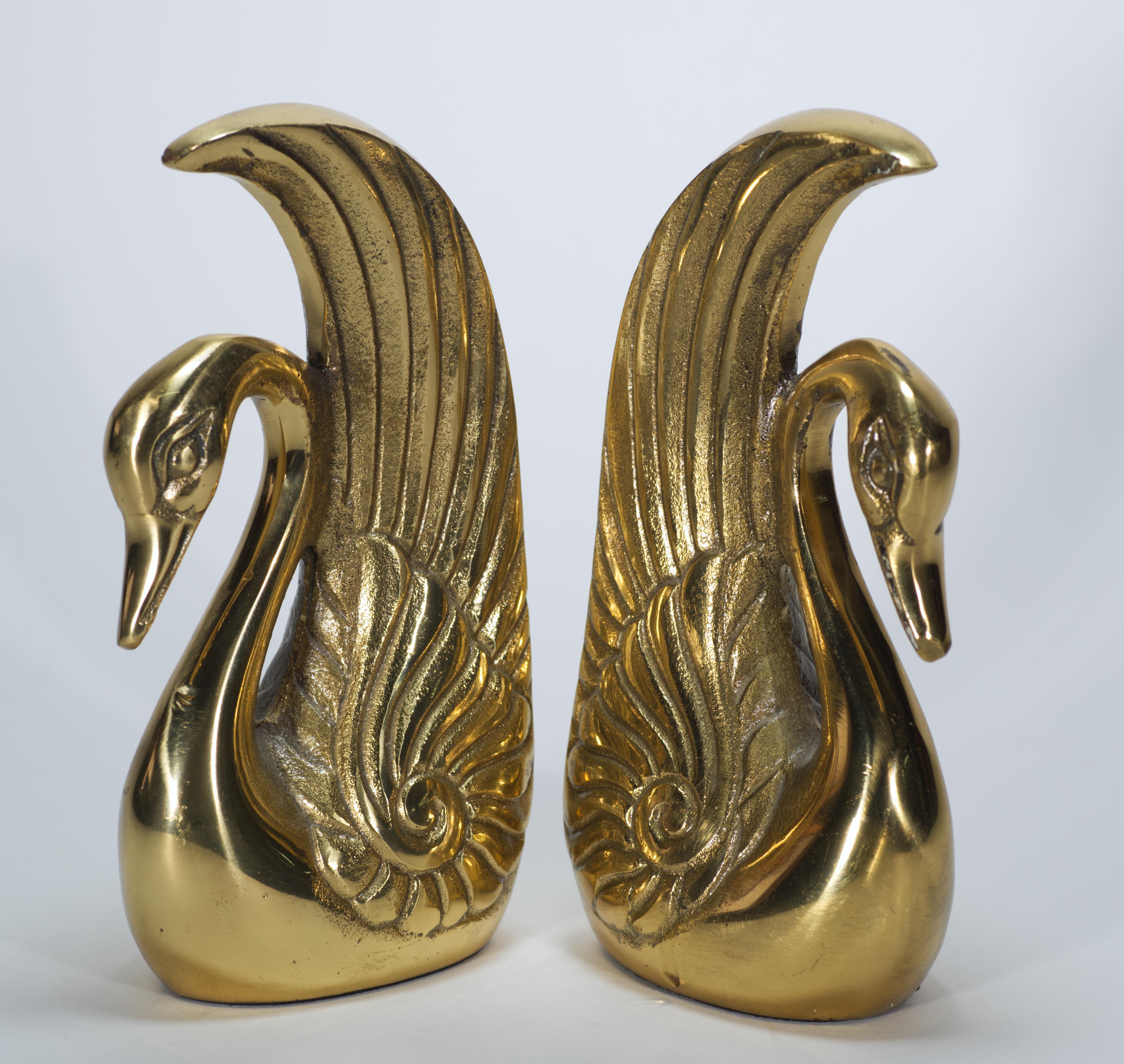  Vintage brass swan bookends feature highly detailed heads and wings that are juxtaposed with polished surfaces of the necks and backs. Variety of the textures adds visual interest to otherwise minimally shaped pieces.

Convenient size and heavy