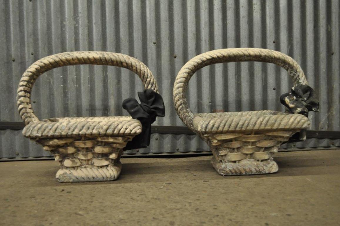 Pair of vintage concrete basket form planters or jardineres. The planters are of a superior quality, with a very realistic rendering of the woven basket forms, and large ribbon accents, circa early to mid-20th century. Measurements: 19.25