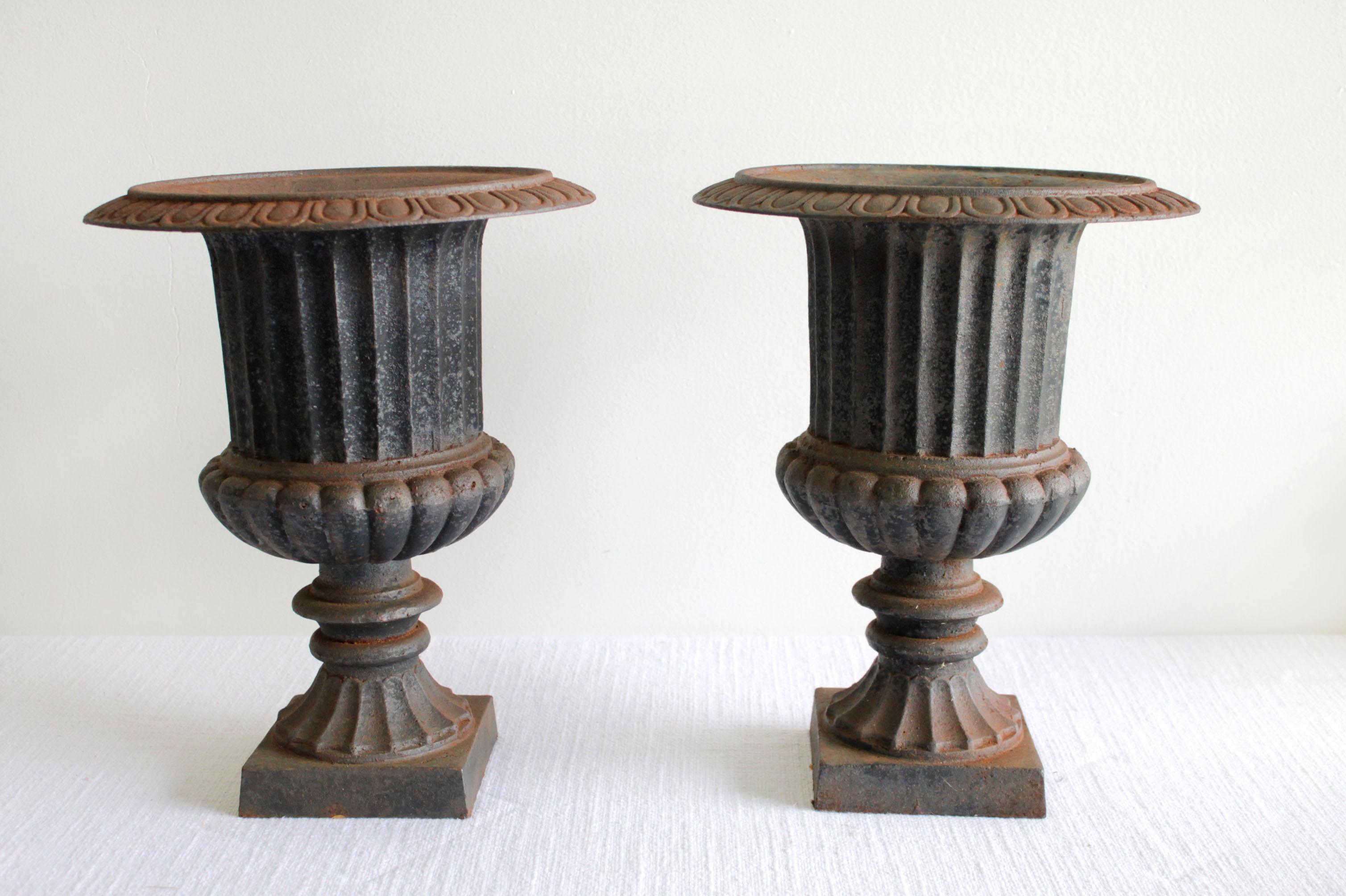 Pair of vintage cast iron pedestal urns
A faded natural patina black that shows age.
Size: 12