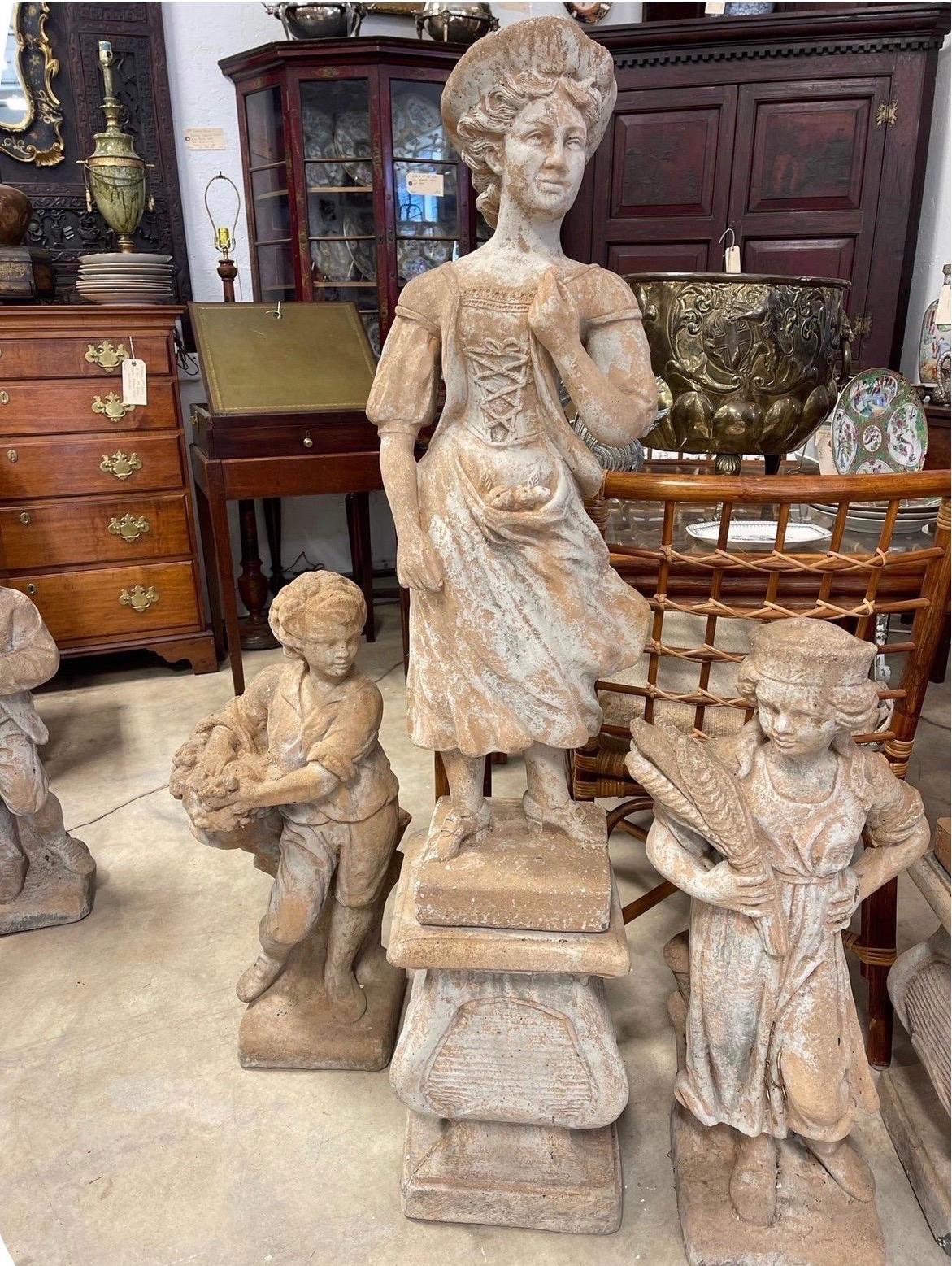 A wonderful pair of vintage cast stone and terracotta victorian figures of a man and women. Perfect for an outdoor entrance! 
Note: They detach from stone bases. Measure:51