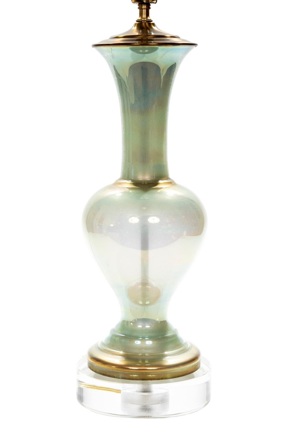 These beautiful shimmering iridescent urn shaped celadon table lamps are mounted on their original brass bases. The beauty of
the lamps is the way they reflect light and the multi dimension of color they exhibit. The 