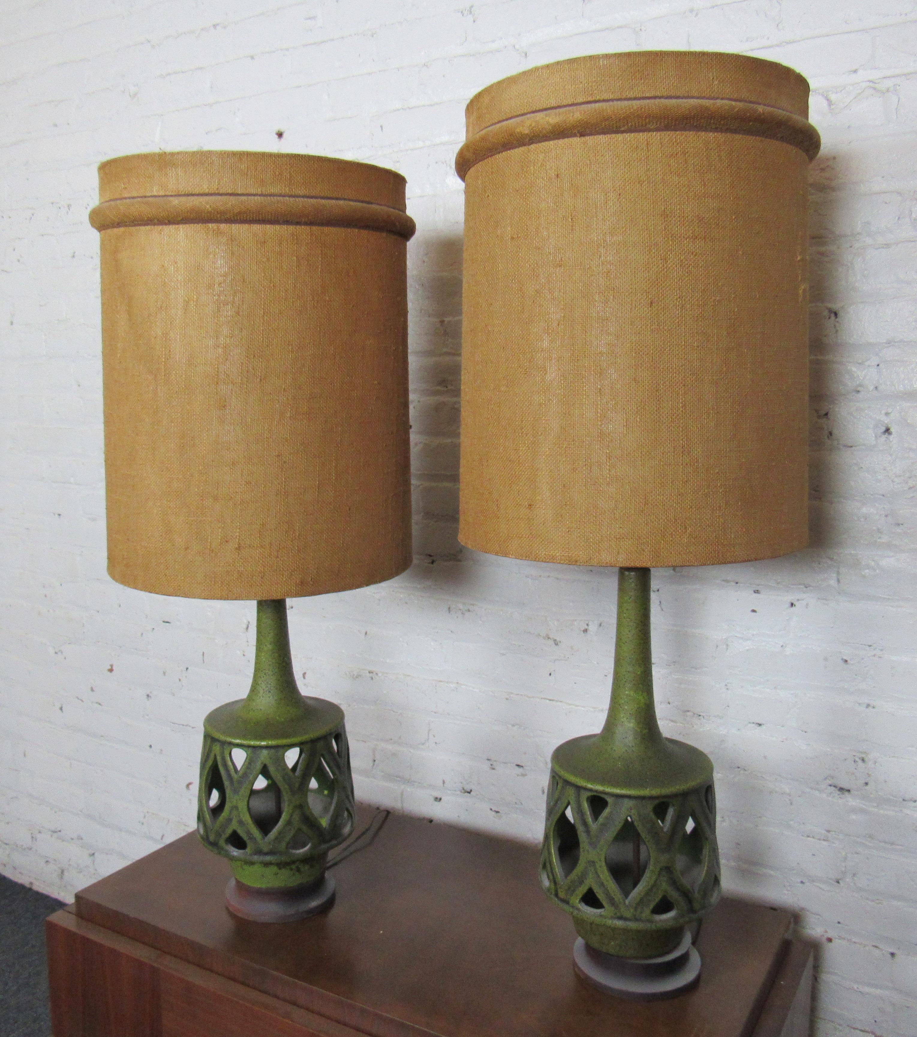 Pair of large vintage table lamps with bases cast in a brilliant green ceramic color. Lampshades are crafted from a tan fabric that make this pair of lamps eye-catching and full of character.

(Please confirm item location - NY or NJ - with
